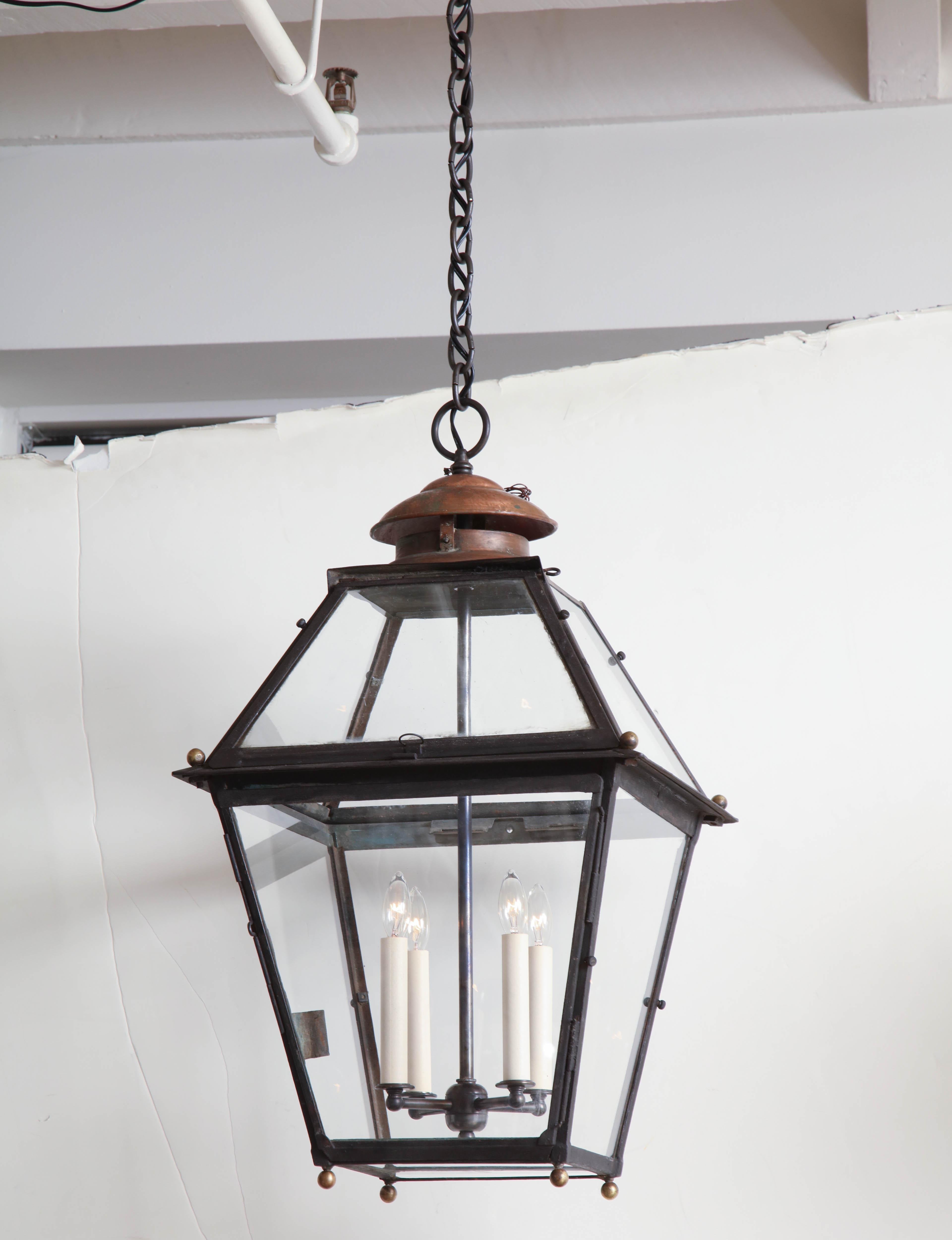 A single black metal and glass square lantern with copper vent and 4 lights. Recently rewired for US specification, France, circa 19th century.
Item No: B8017

Size: 16.5” W, 16.5” D, 27.5” H.
 
