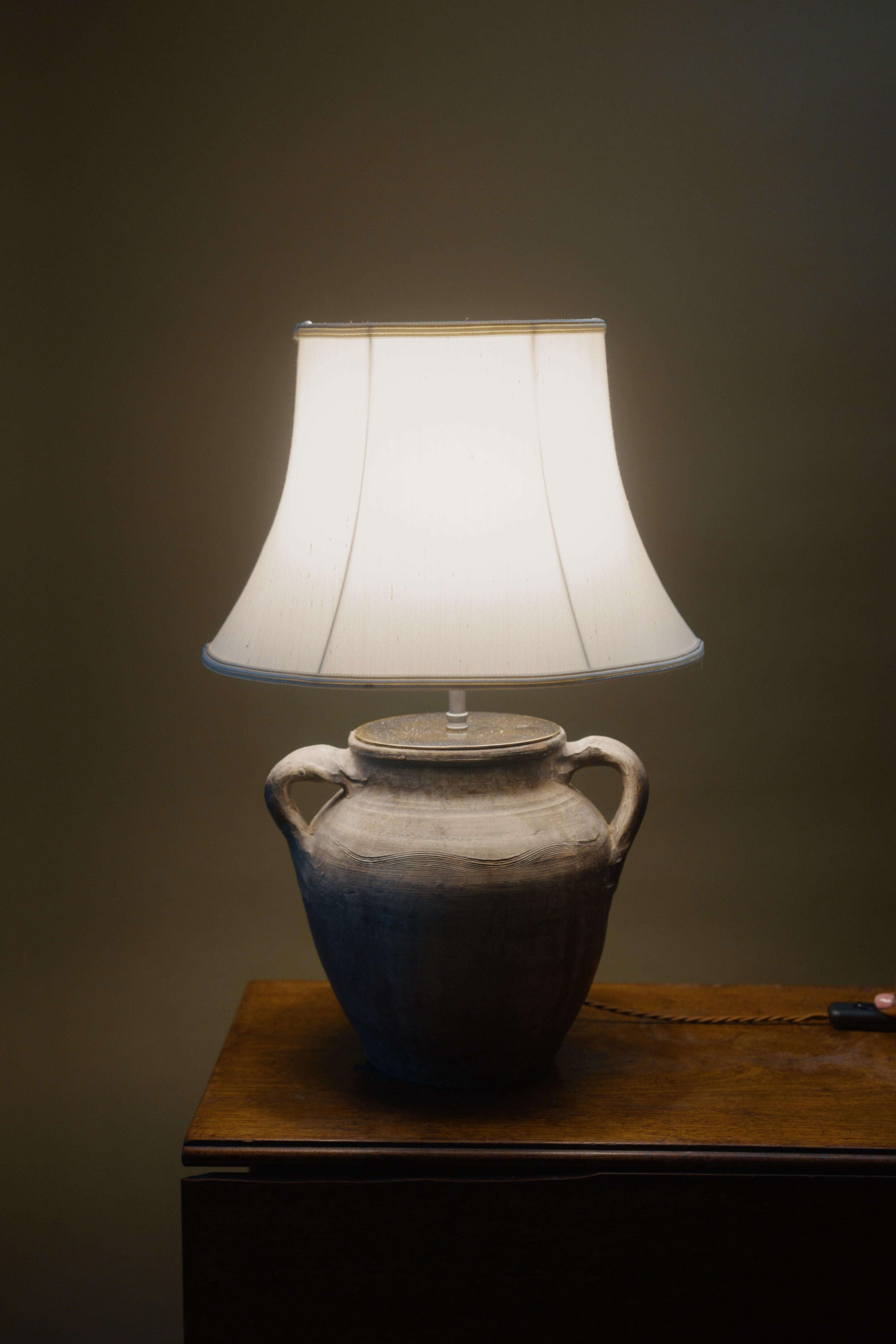 Description: This 20th century Black Sea Heritage lamp showcases exquisite artisan craftsmanship and timeless design. Handcrafted from a vintage Mediterranean clay pot, it reflects over 60 years of history with its unique weathered patina, perfect