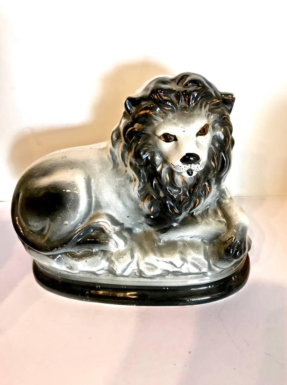 This is an iconic Staffordshire recumbent lion in the uncommon black and white coloration. This beast is in overall very good to excellent condition. Integrates well into English country houseor traditional design.