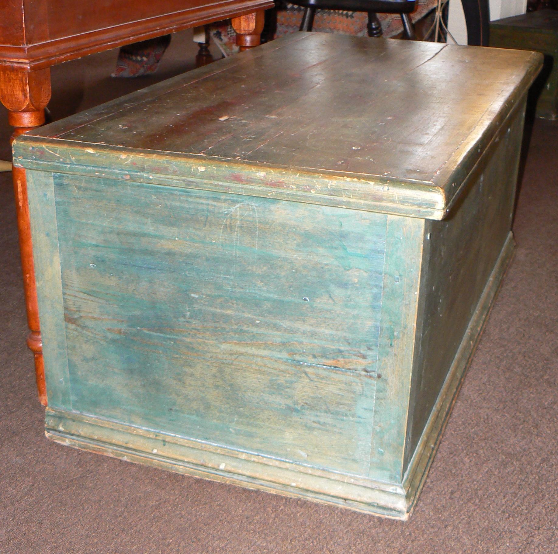 19th century blanket chest in old green paint with molded top and base.