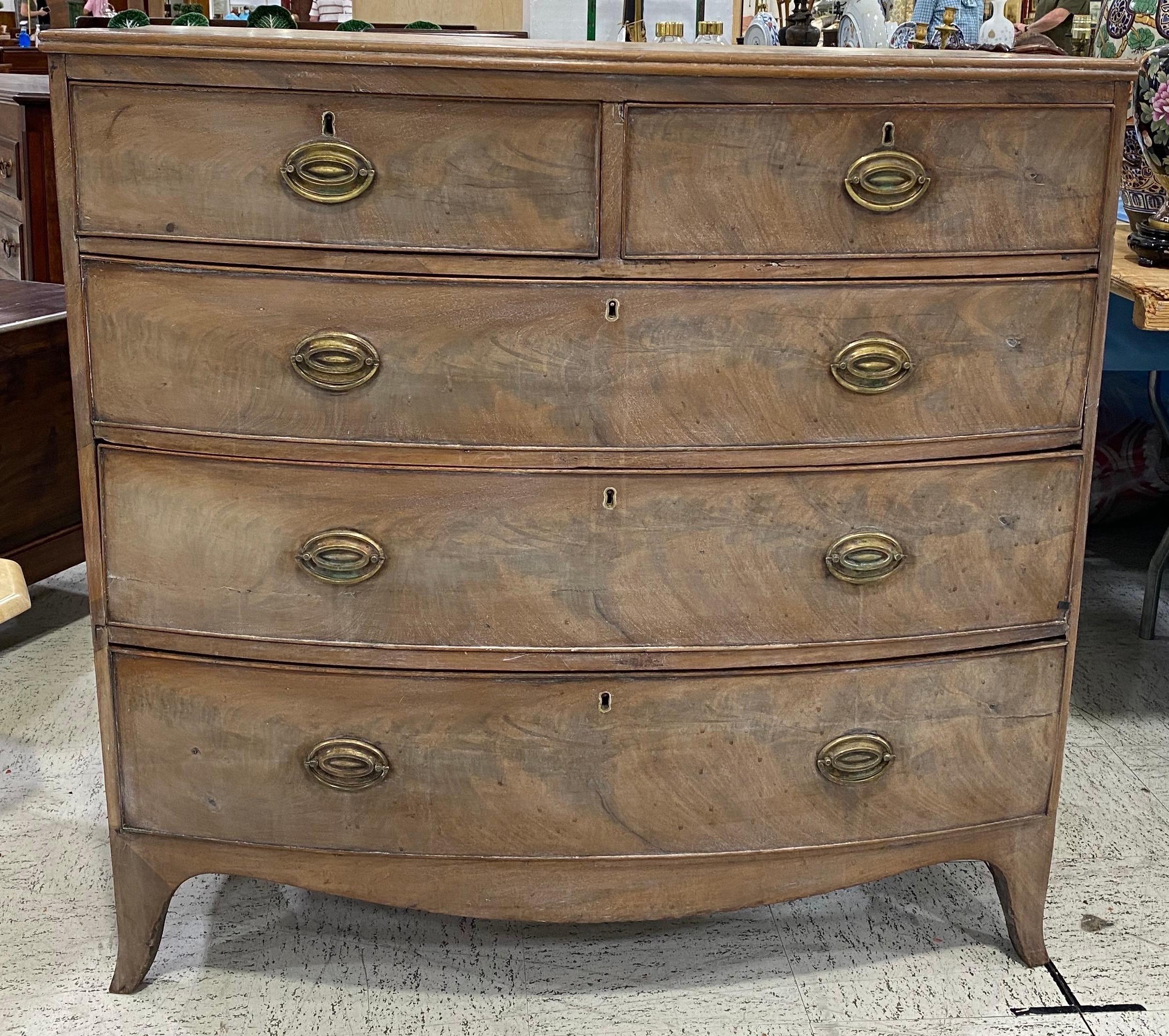 Great color on this 19th century bleached English mahogany bowfront chest of drawers. 2 drawers over 3, resting on bracket feet.