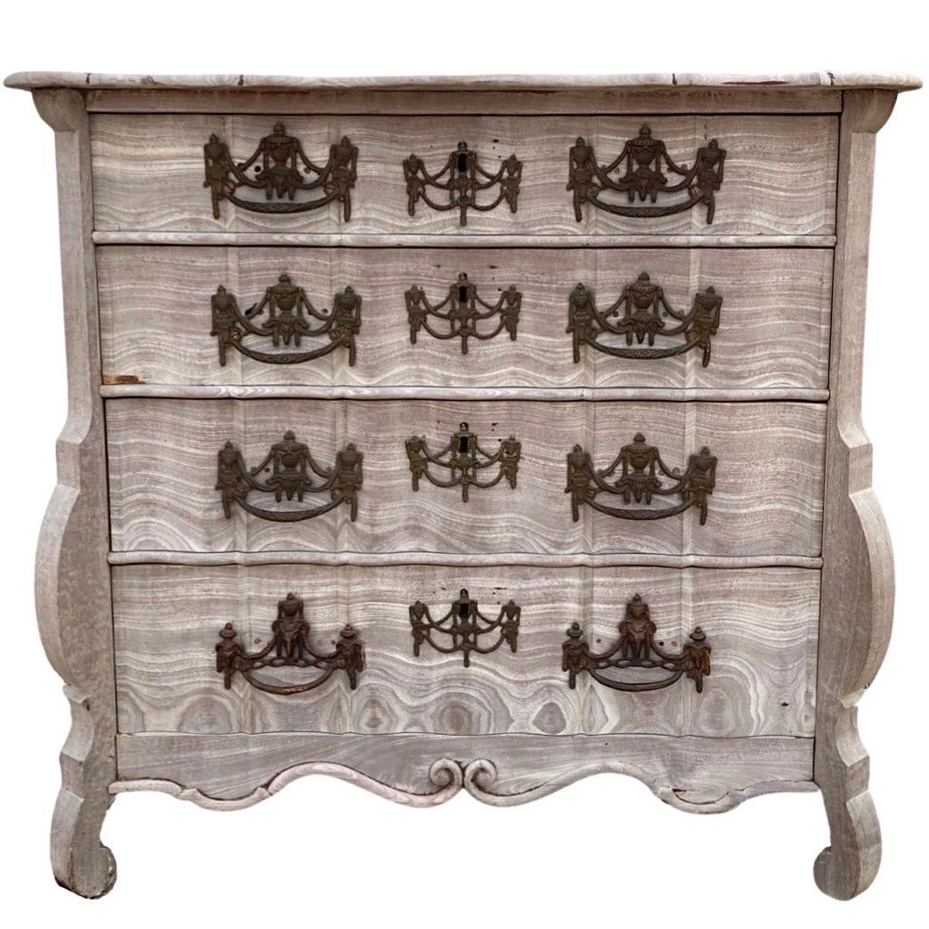 Small chest of drawers hand-built in the Netherlands in the early 1800s using mahogany. This little guys packs a lot of character and details in one small package! The chest features four drawers with serpentine drawer fronts and showing square