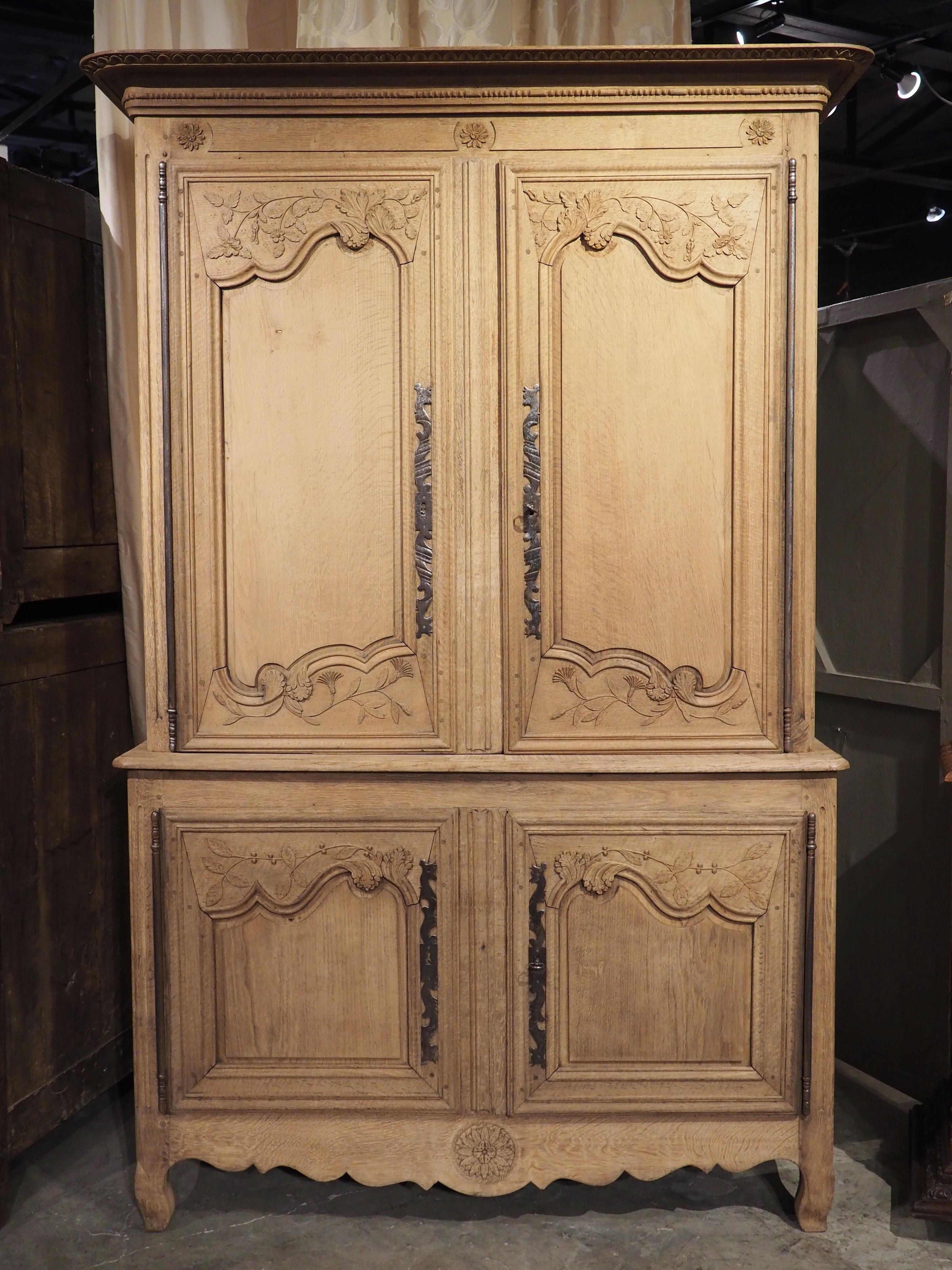 A handsome and robust storage piece, this buffet deux corps was hand-carved in Haute-Normandie (“Upper Normandy”), France during the 19th century. The underside of the flat crown has been embellished with repeating niches above a cavetto molding.