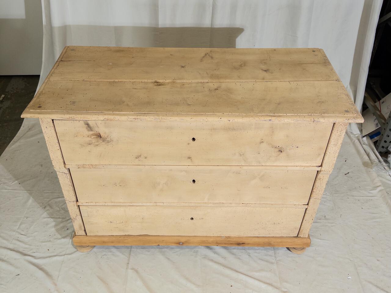 Transport your space to the rustic elegance of 19th-century France with this charming bleached pine chest. Each drawer tells a story of craftsmanship and history. The weathered finish adds character, echoing the passage of time with grace. With