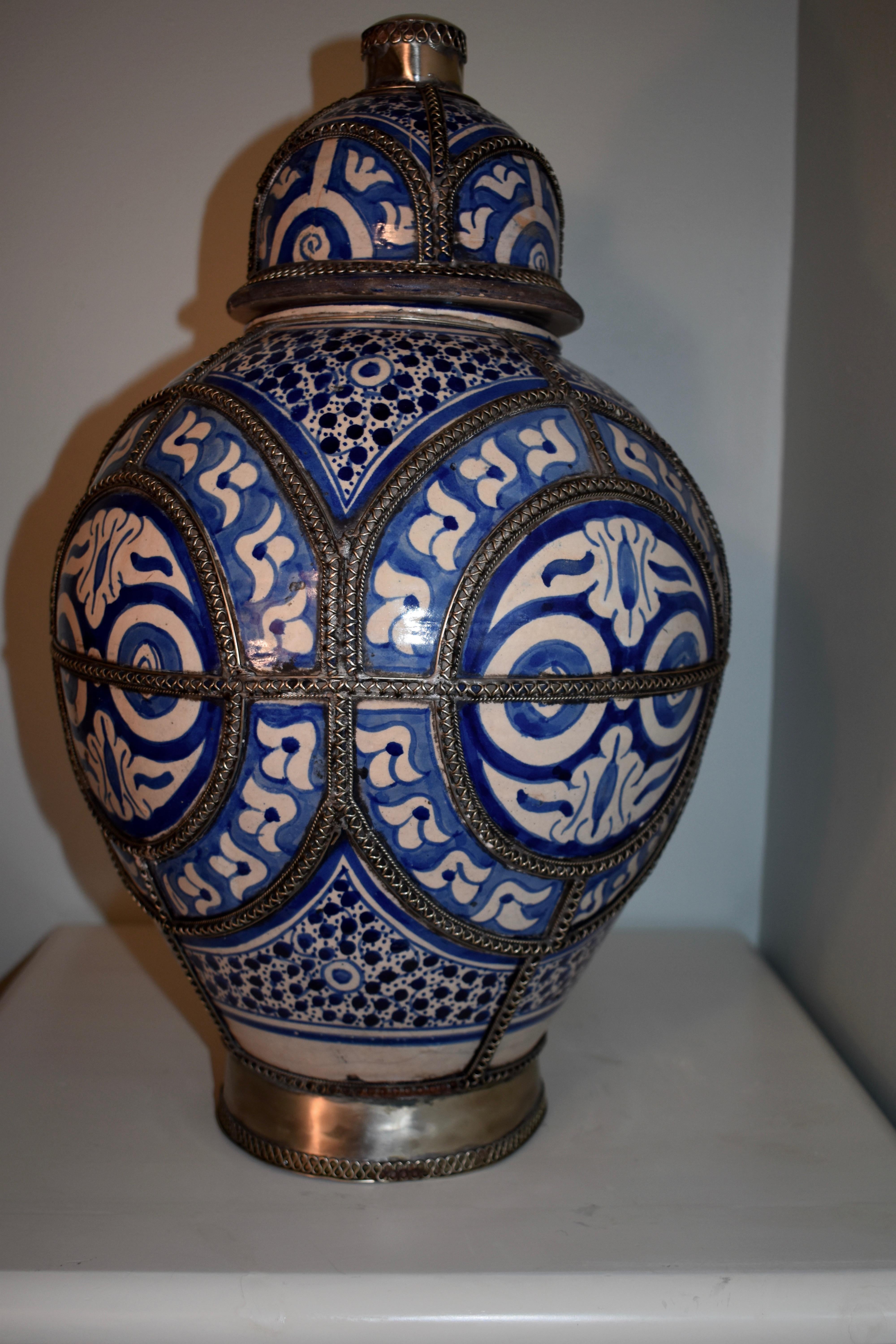 19th century blue and white ceramic urn vase. Fez, Morocco. Moorish style handcrafted urn with painted florals, filigree silver nickel work. Antique Hispano Moresque design on ceramic bleu de Fez urn. Measures: 19 H x 12