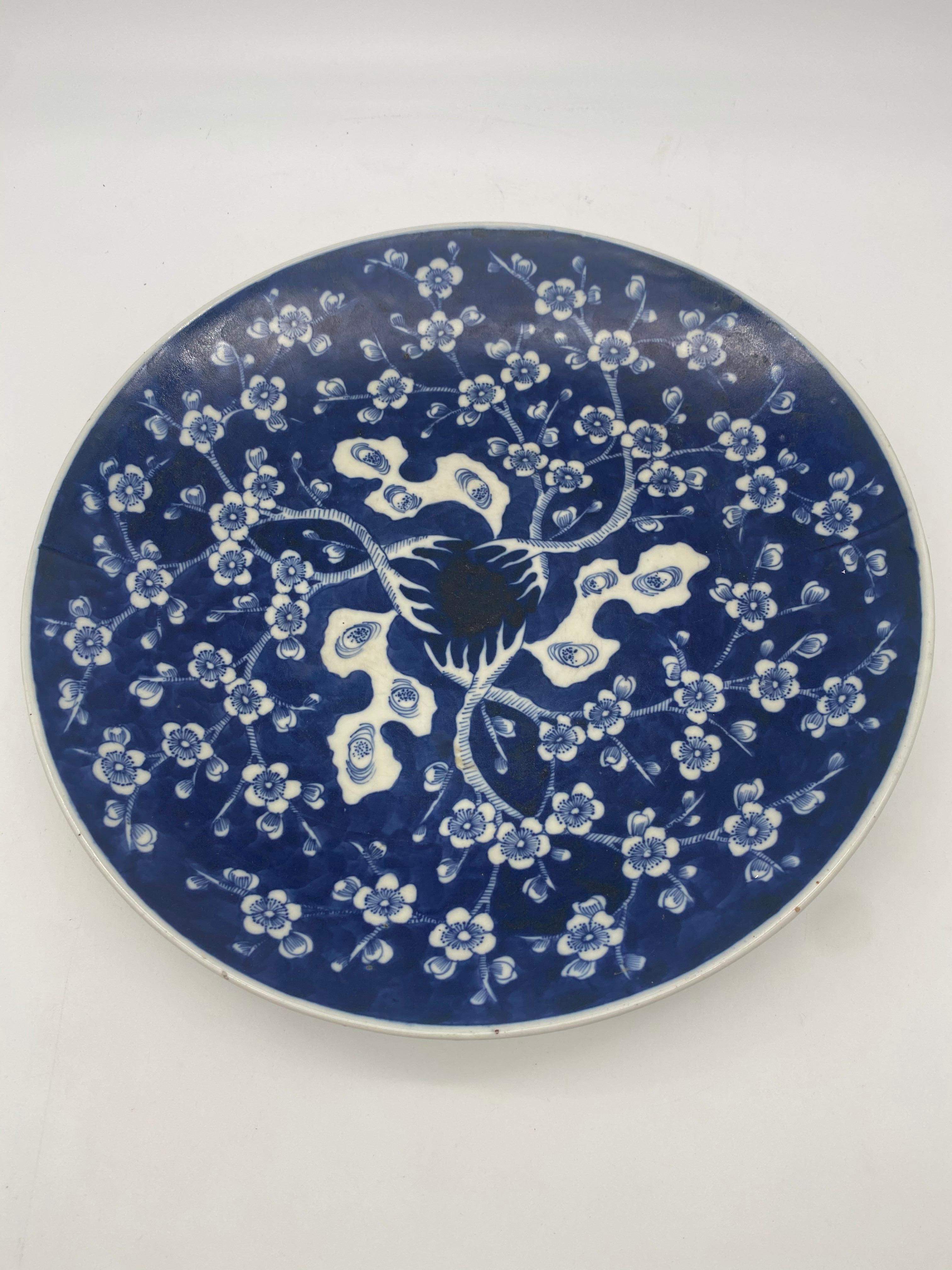 19th century blue and white Japanese porcelain dish Meiji period decorated with prunus on the cobalt blue ground, inscription to base, Ex Bonhams lot 268 diameter 12 inch.
