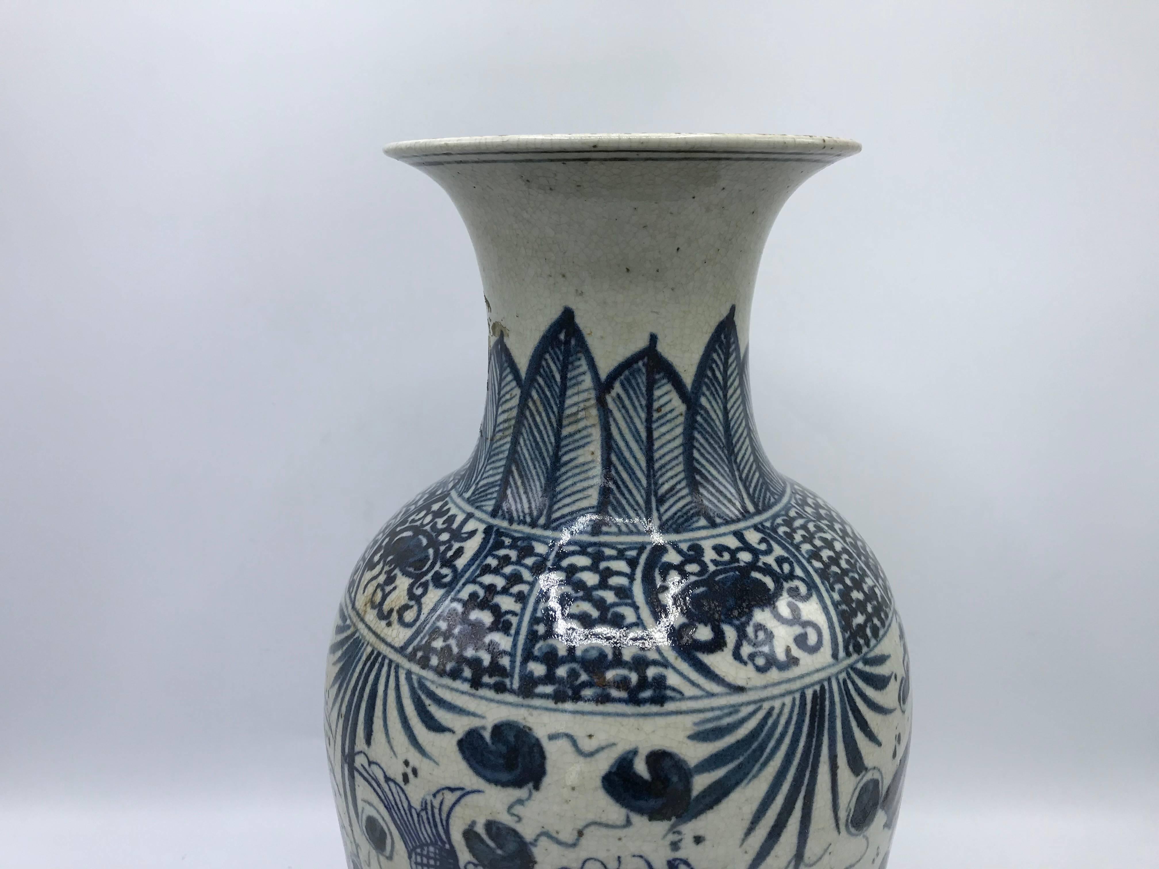 Listed is a stunning, Early 20th C. blue and white chinoiserie vase, with a fish motif and calligraphy. Heavy. 

We have a second available, slightly different, but makes a great pair!