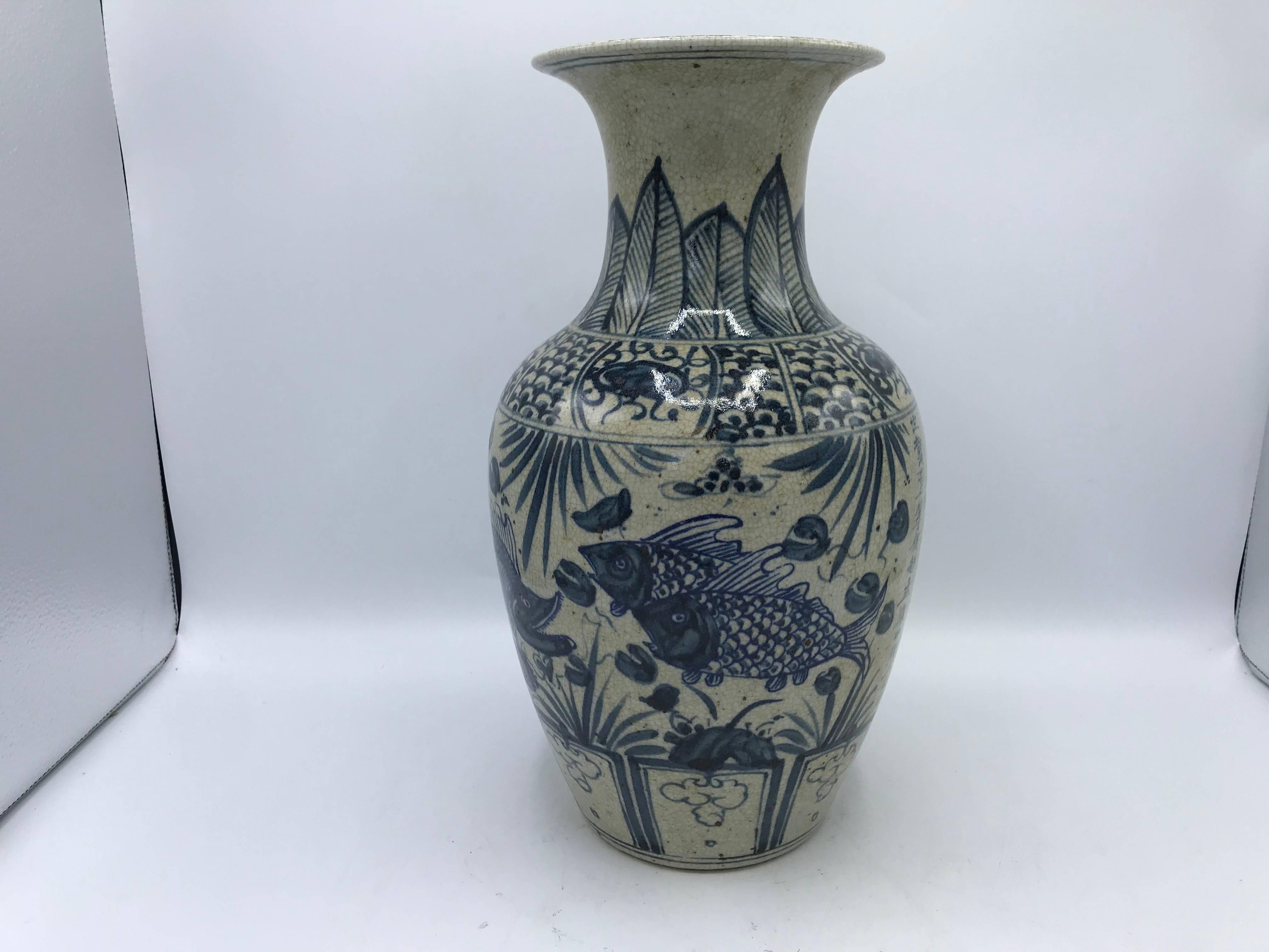 Listed is a stunning, Early 20th C. blue and white chinoiserie vase, with a fish motif and calligraphy. Heavy. 

We have a second available, slightly different, but makes a great pair!
