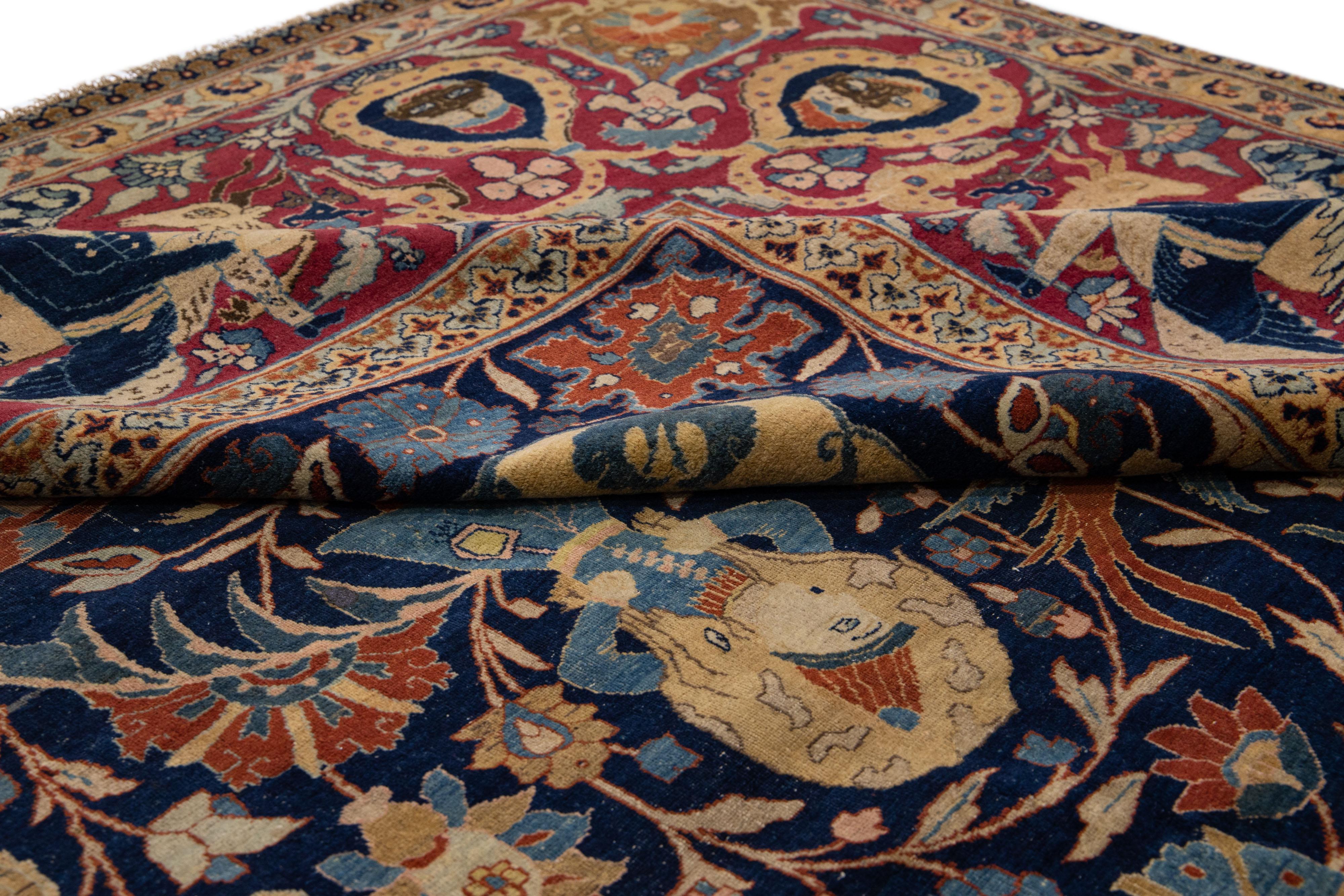 Beautiful Antique hand-knotted wool rug with a blue color field. This rug has a red frame with multicolor accents in an all-over geometric floral design.

This rug measures 12'4