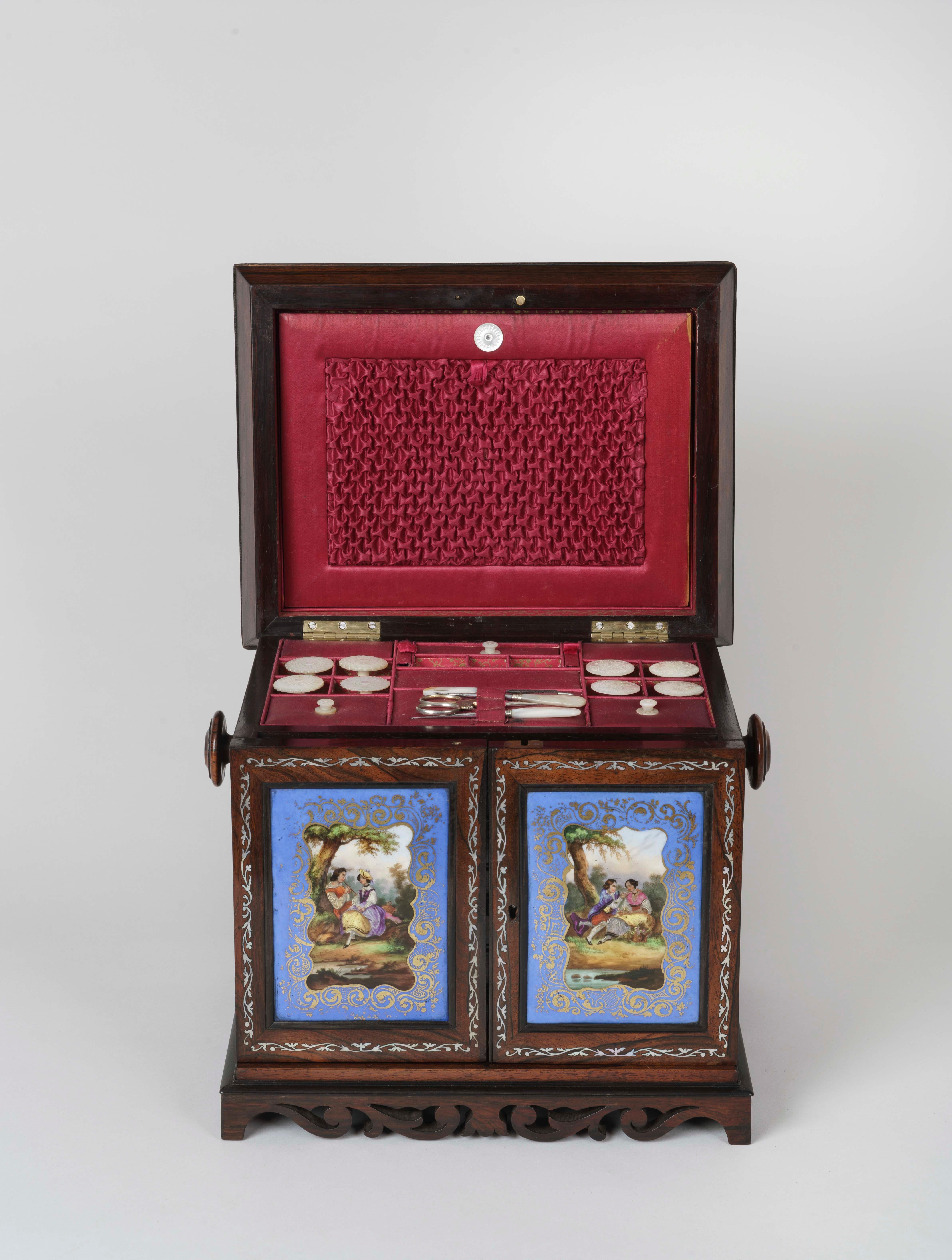 A Fine Table Cabinet

Rising from scrolling foliate bracket feet, the rectangular cabinet constructed in rosewood and surmounted with a hinged cavetto moulded lid set with a Sèvres-style porcelain plaque and a mother-of-pearl inlaid border, the lid