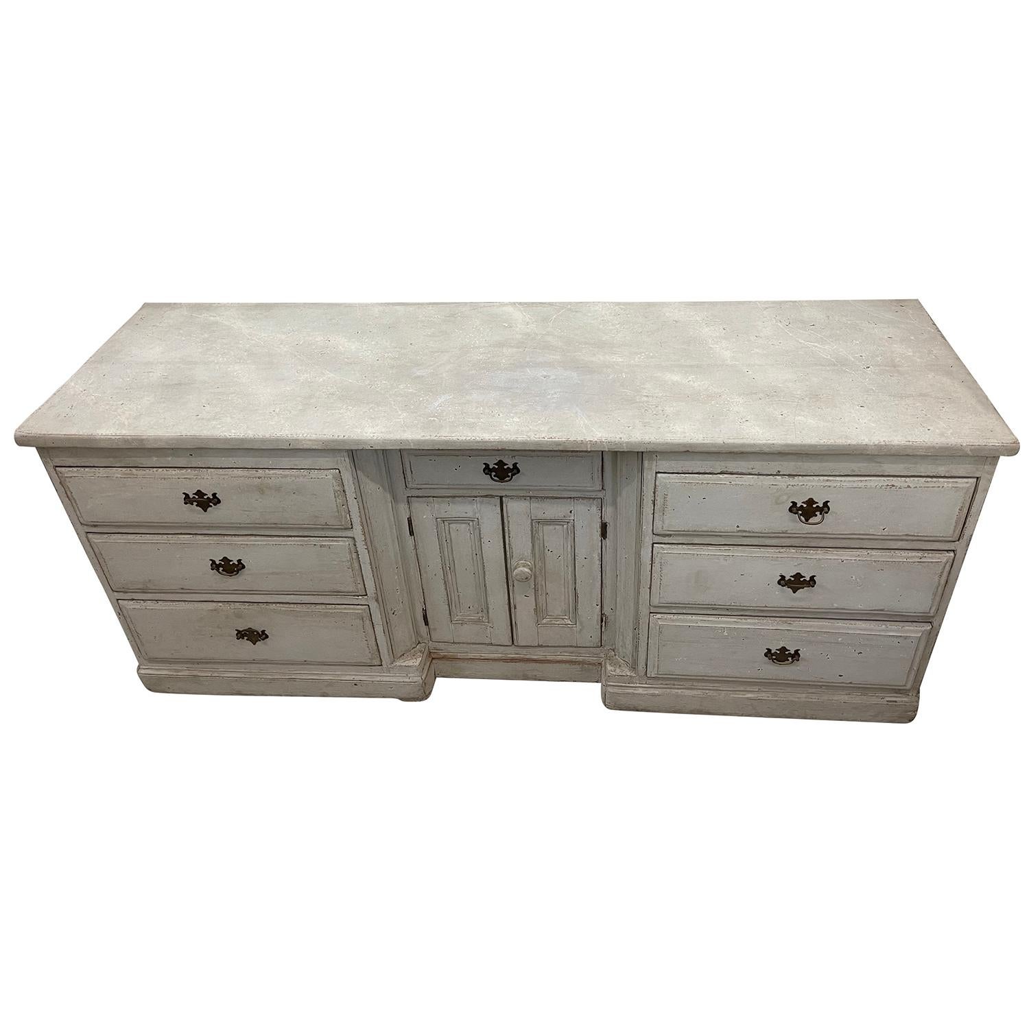 An antique Swedish Gustavian chest of drawers with two doors and six drawers, made of hand crafted painted Pinewood and chrome, in good condition. The Scandinavian sideboard is detailed in the Neoclassical Greek style with the original hardware and