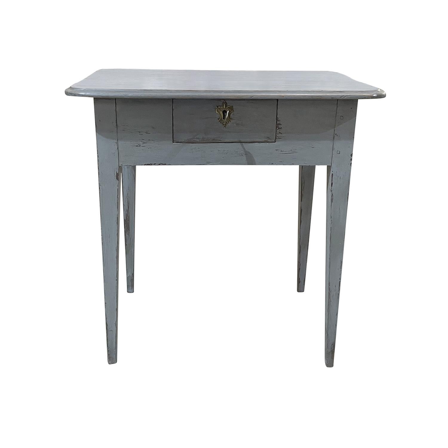 A blue-grey, antique Swedish Gustavian single center, kitchen table made of hand crafted painted Pinewood, in good condition. The Scandinavian side table is composed with one drawer, consisting its original detailed bronze hardware and key, standing