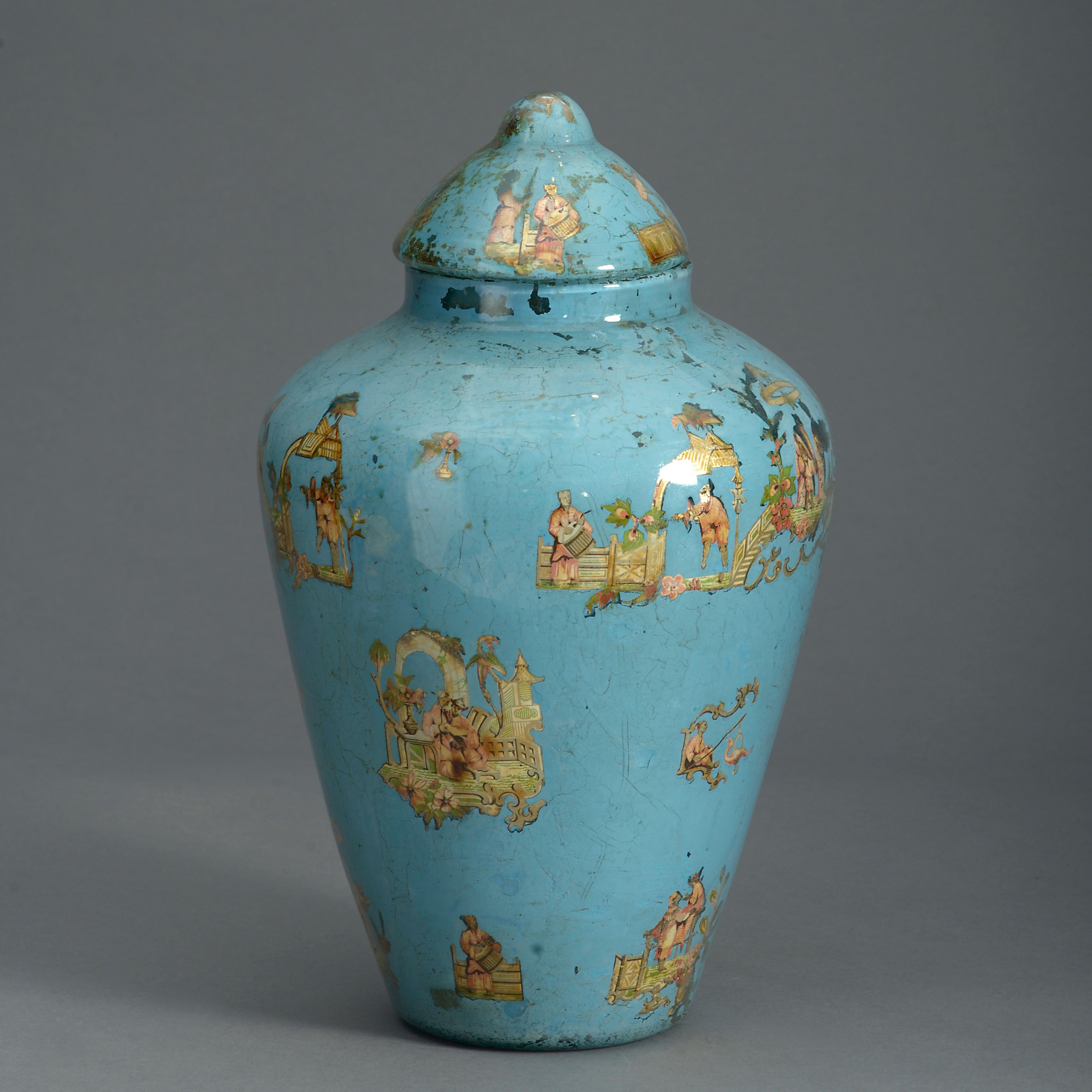 A charming mid-nineteenth century pale decalcomania vase and domed lid, decorated throughout with chinoiseries on a pale blue ground.

This is an unusual example of decalcomania. The decoupage work closely resembles arte povera of the eighteenth