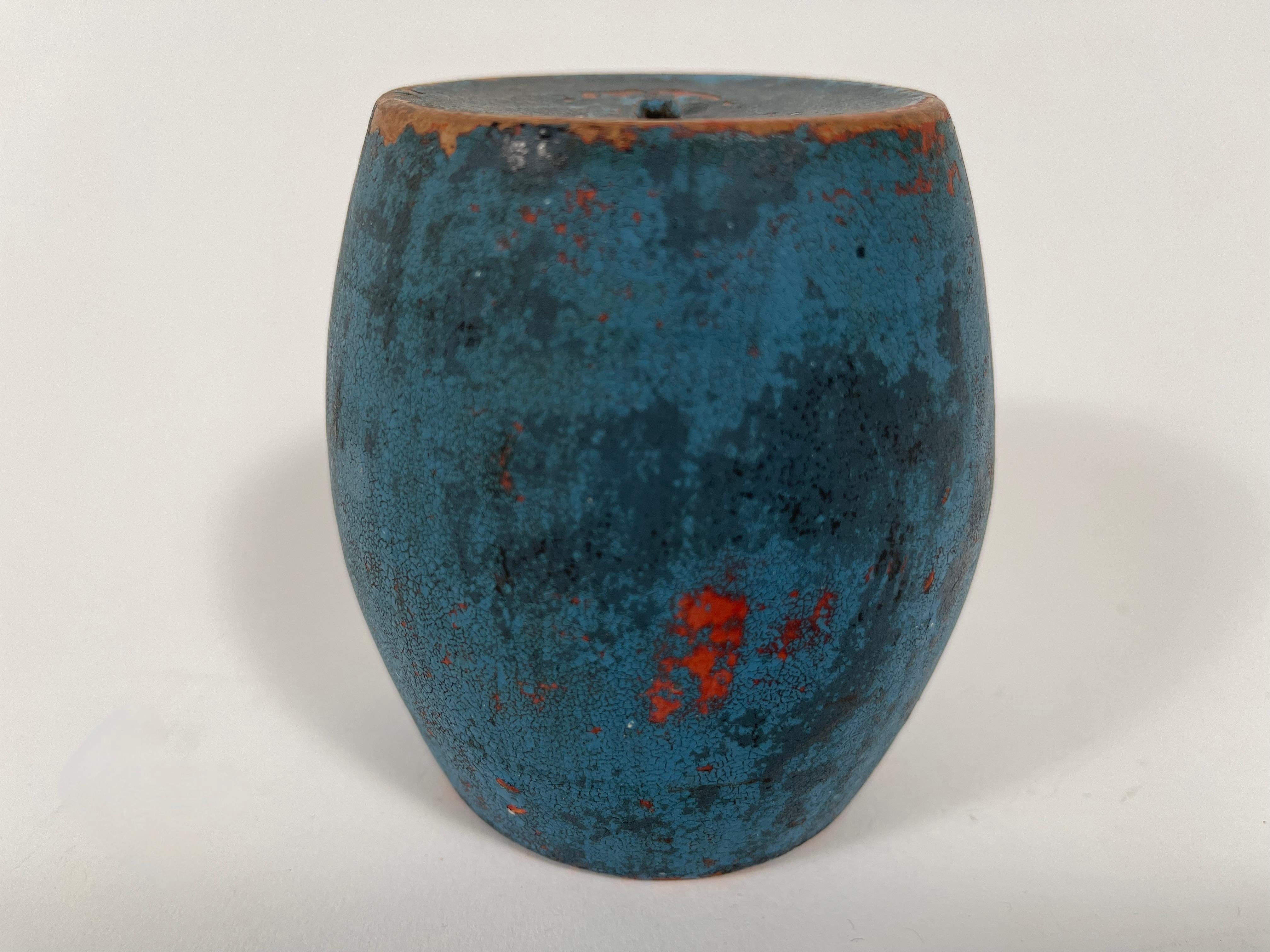 A 19th century American blue painted red ware pottery barrel-form bank. With its beautiful color, patina and form, this ceramic coin bank is a beautiful decorative object which reads as both country and modern at once.