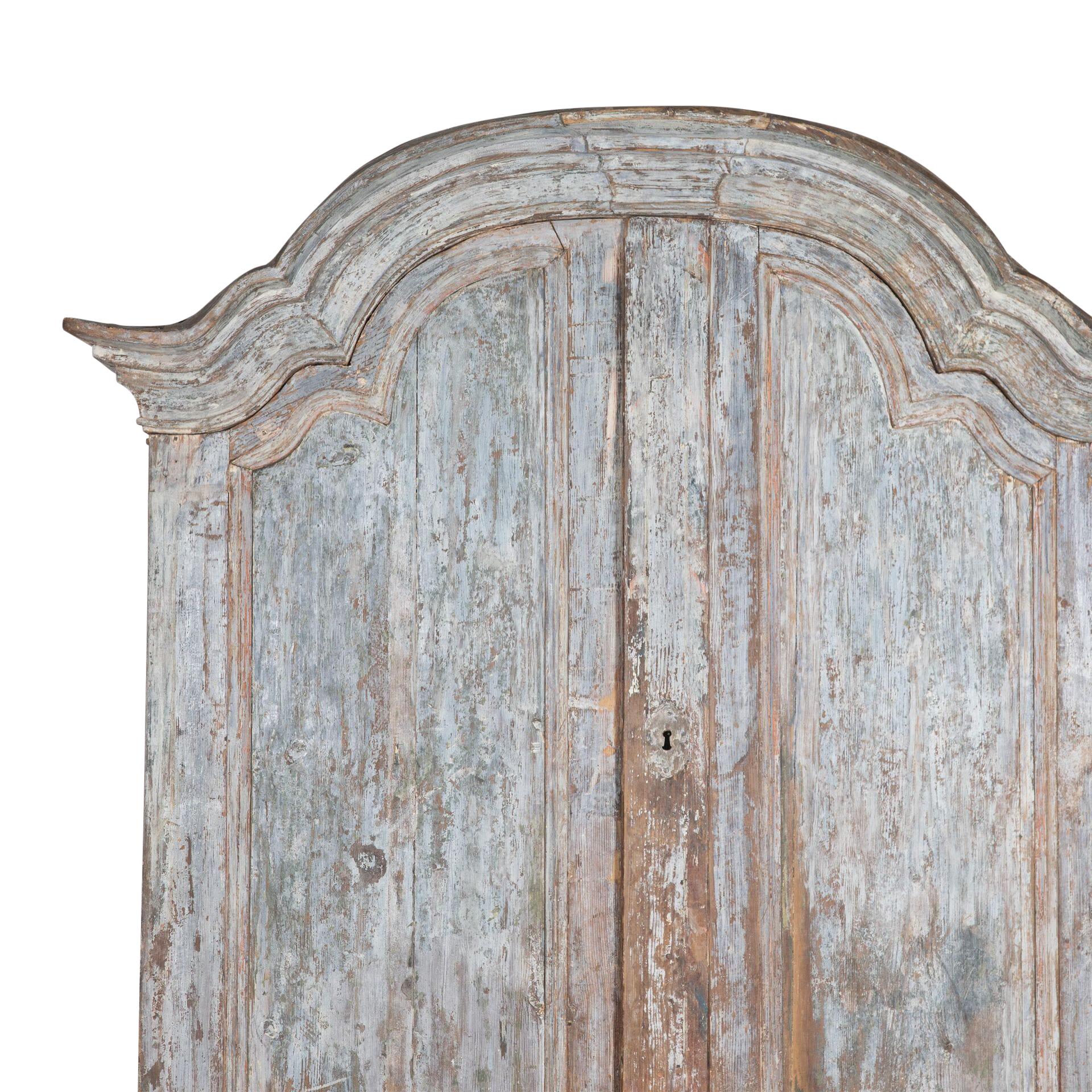 19th Century Rococo cupboard from the region of Fryksdalen Sweden.
Below the decorative carved pediment are two large doors opening to useful storage and then further below are two doors with carving opening to further storage.
Scraped to wonderful