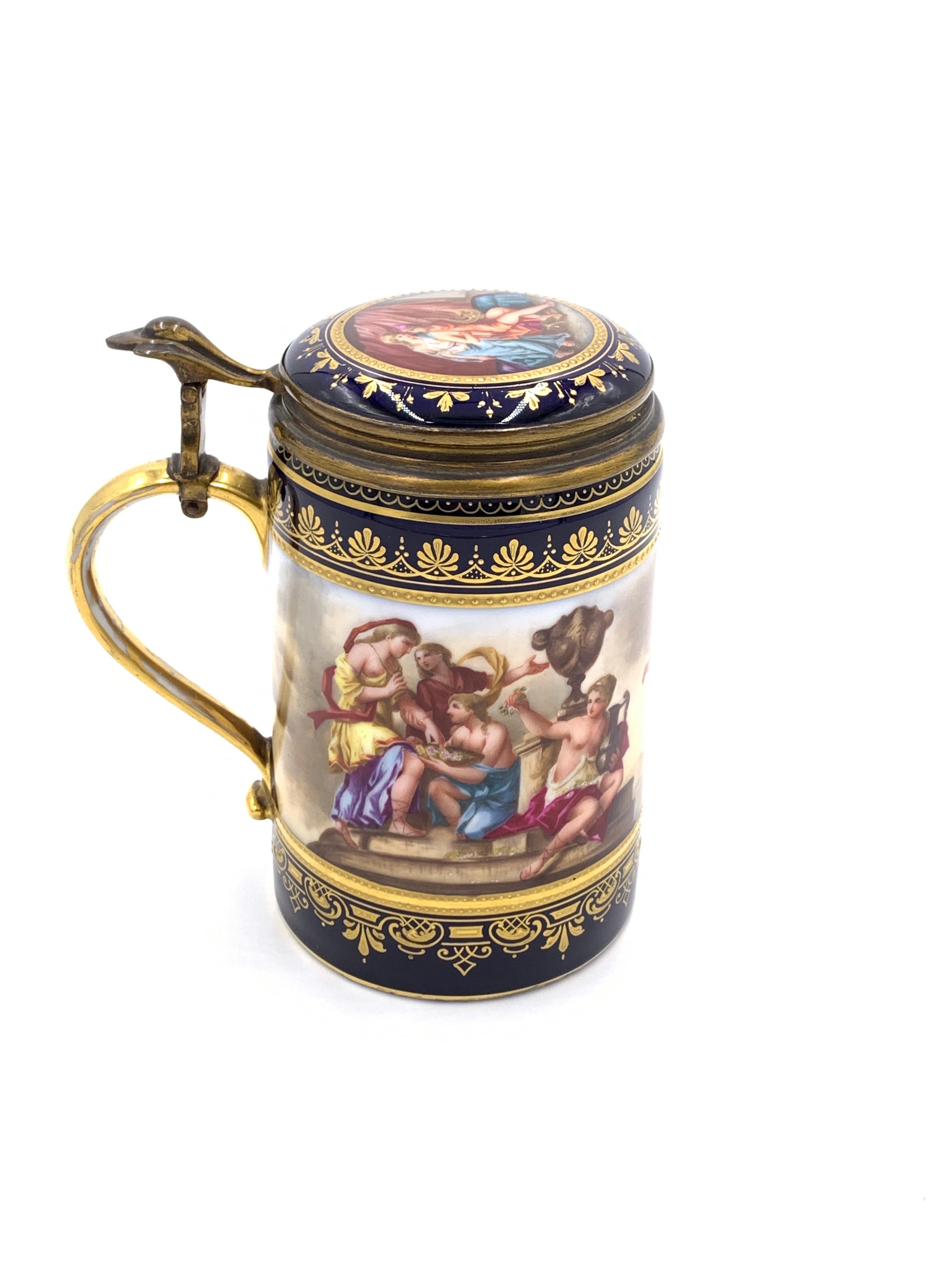 19th century Royal Vienna Porcelain lidded tankard, gilt metal above the handle and attached to the lid, decoration all around the out side and on the inner lid, blue beehive mark stamped on the base.