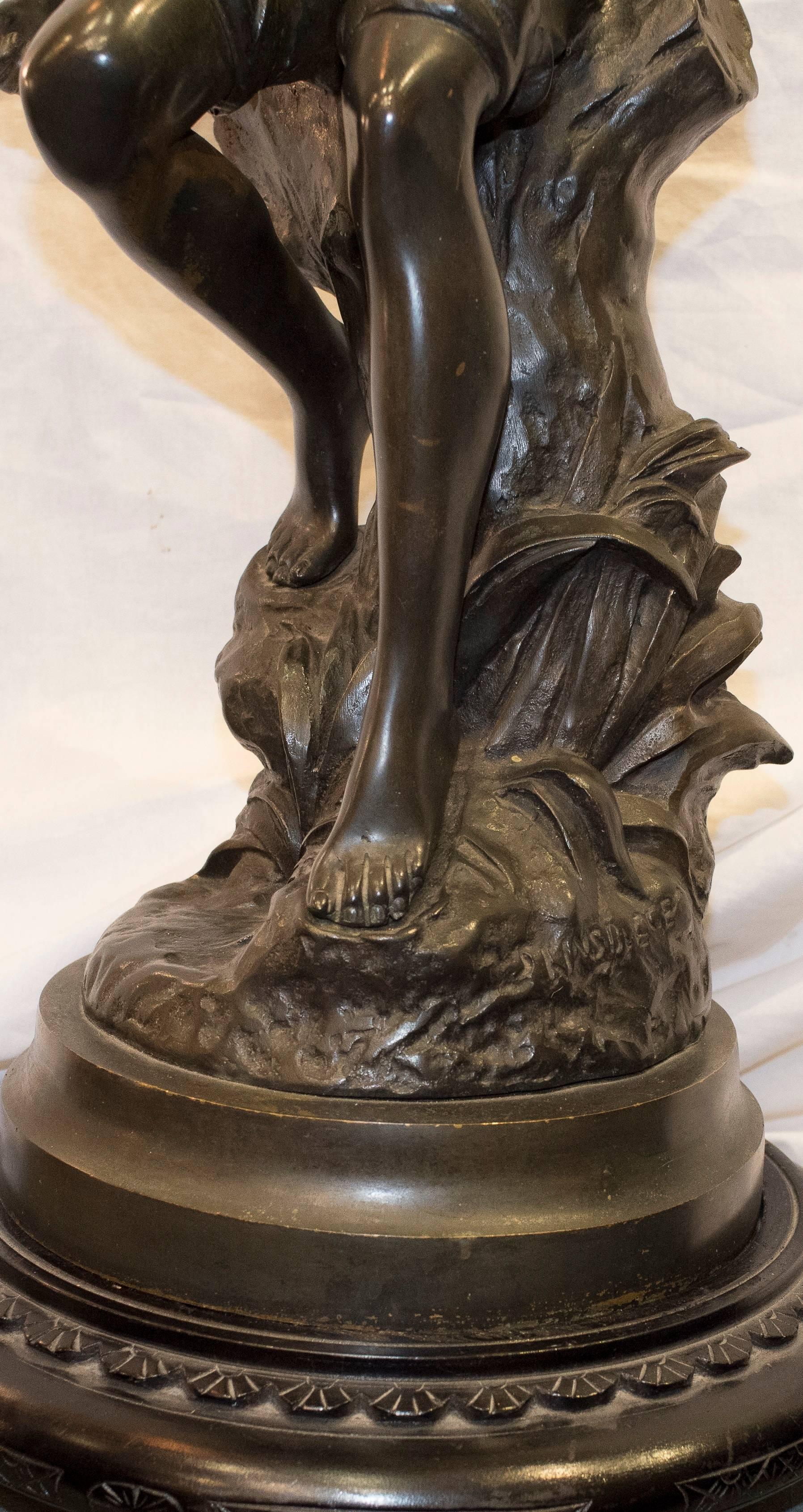 One of a kind 19th century French sculpture in blued bronze, is a young fisherman. Signed.