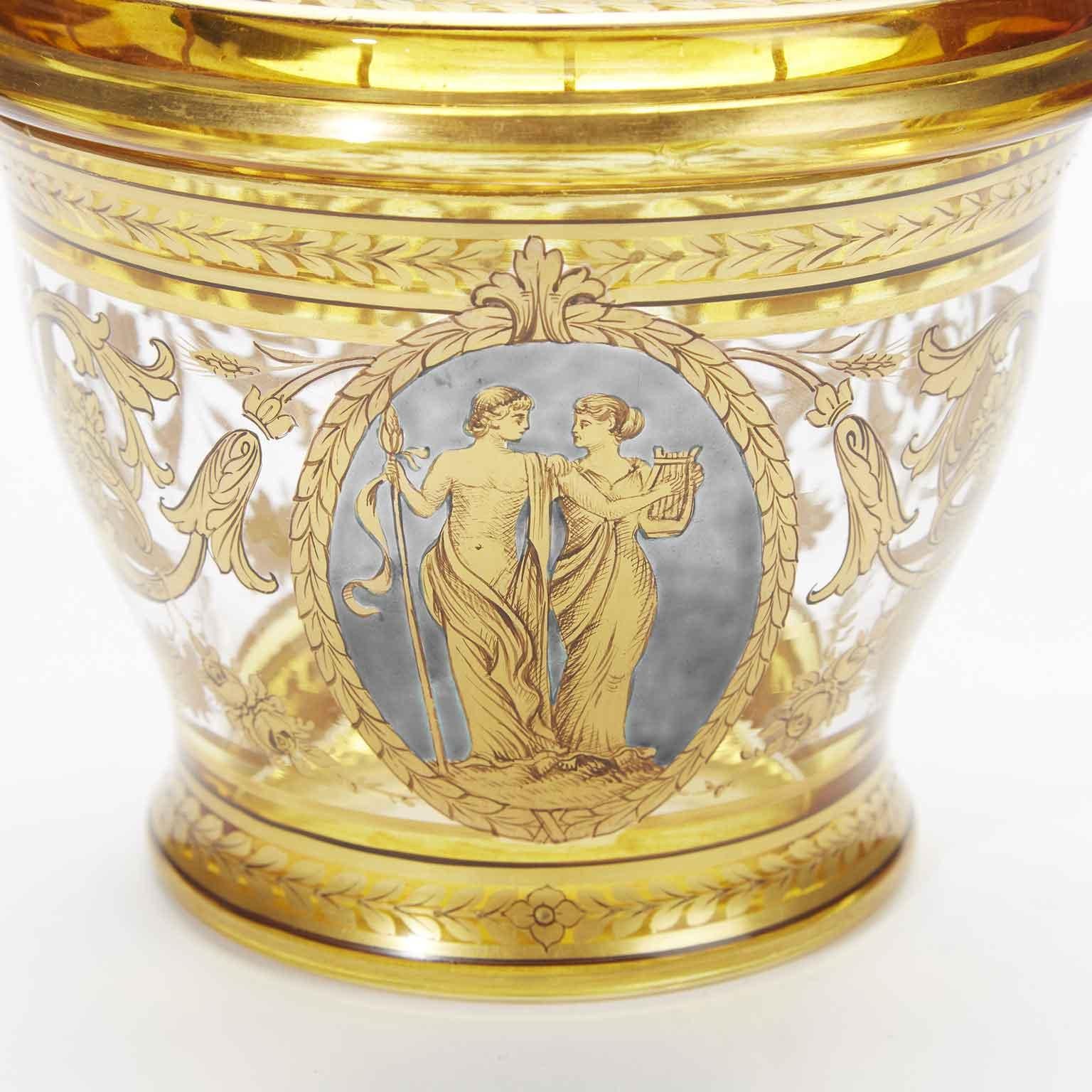 19th century Bohemian gilded crystal vase with cover, an extraordinary elegant blue and gilt crystal circular lidded box with a superlative scrolling and vegetal gilt decoration and a Biedermeier oval blue miniature with two figures.
Of Mittle