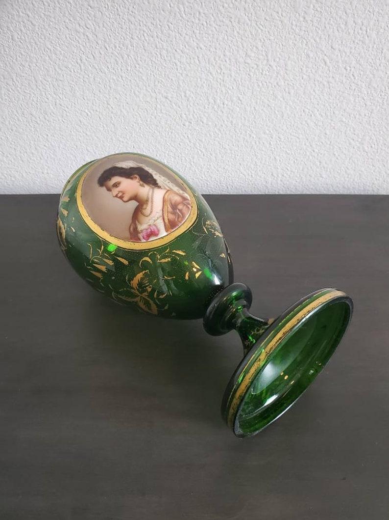 Bohemian parcel-gilt green glass portrait vase, attributed to Moser, Czech Republic, bulbous form, centering hand-painted figural reserve featuring young maiden, tapering toward round base, with parcel-gilt foliate accents throughout, some loss to