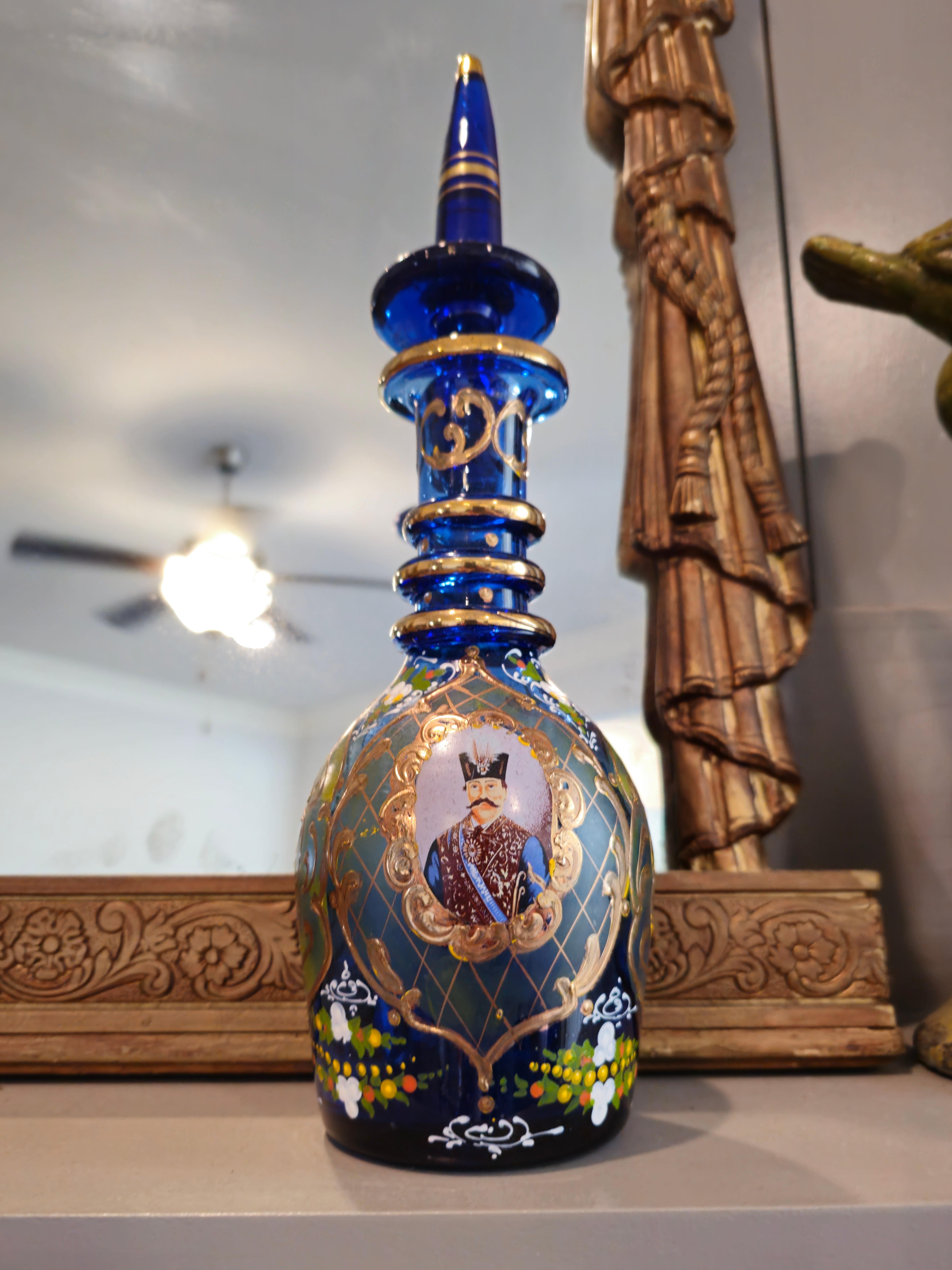 A scarce pair of fine quality antique Bohemian parcel gilt enameled light cobalt blue glass decanter bottles, exquisitely decorated for the Persian market. circa 1890

Handmade in Bohemia (present day Czech Republic) in the late 19th century, home