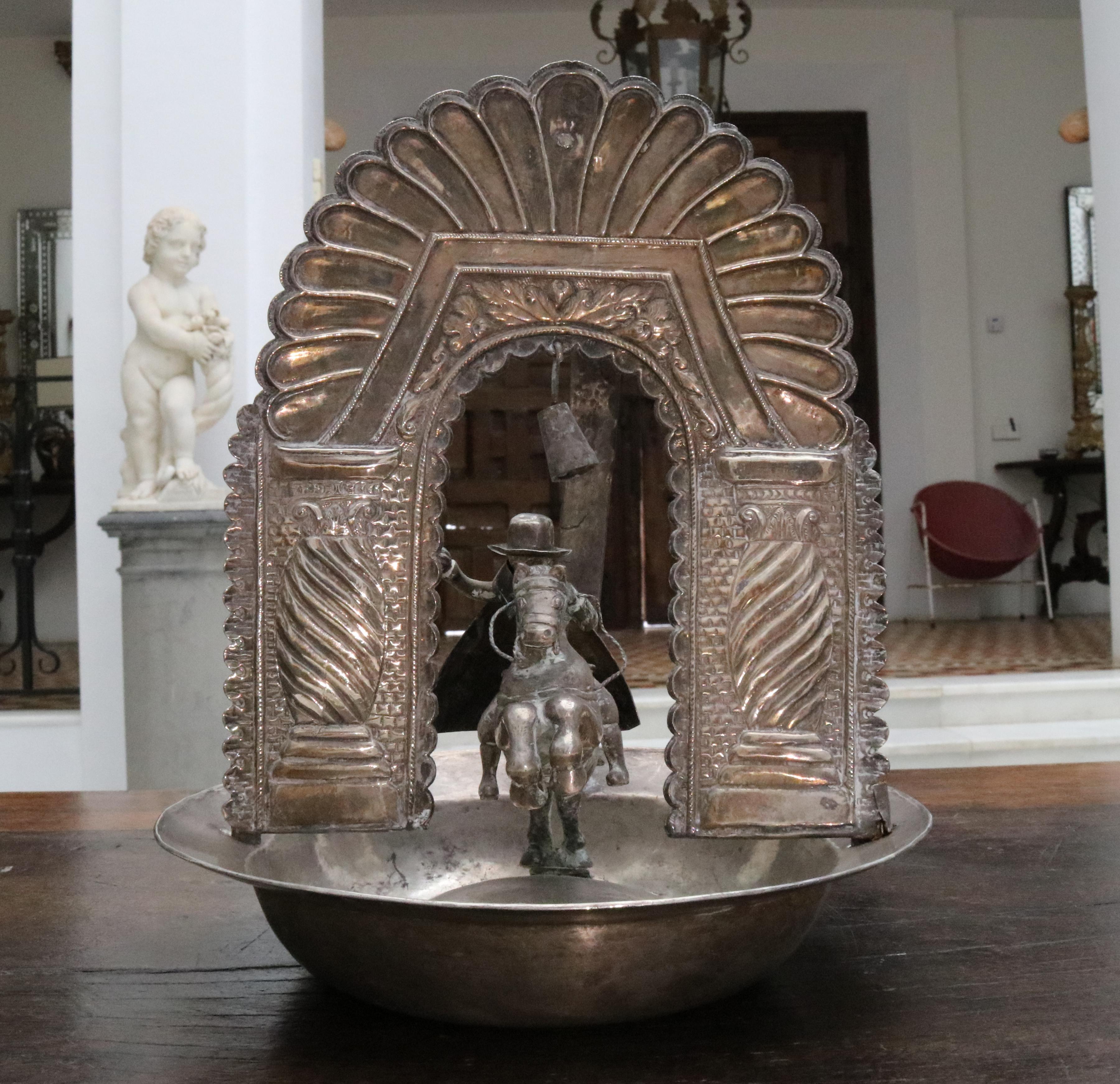 19th century Bolivian or Peruvian silver alms dish with Saint James riding a horse. 

Total silver by weight: 1.291 g.