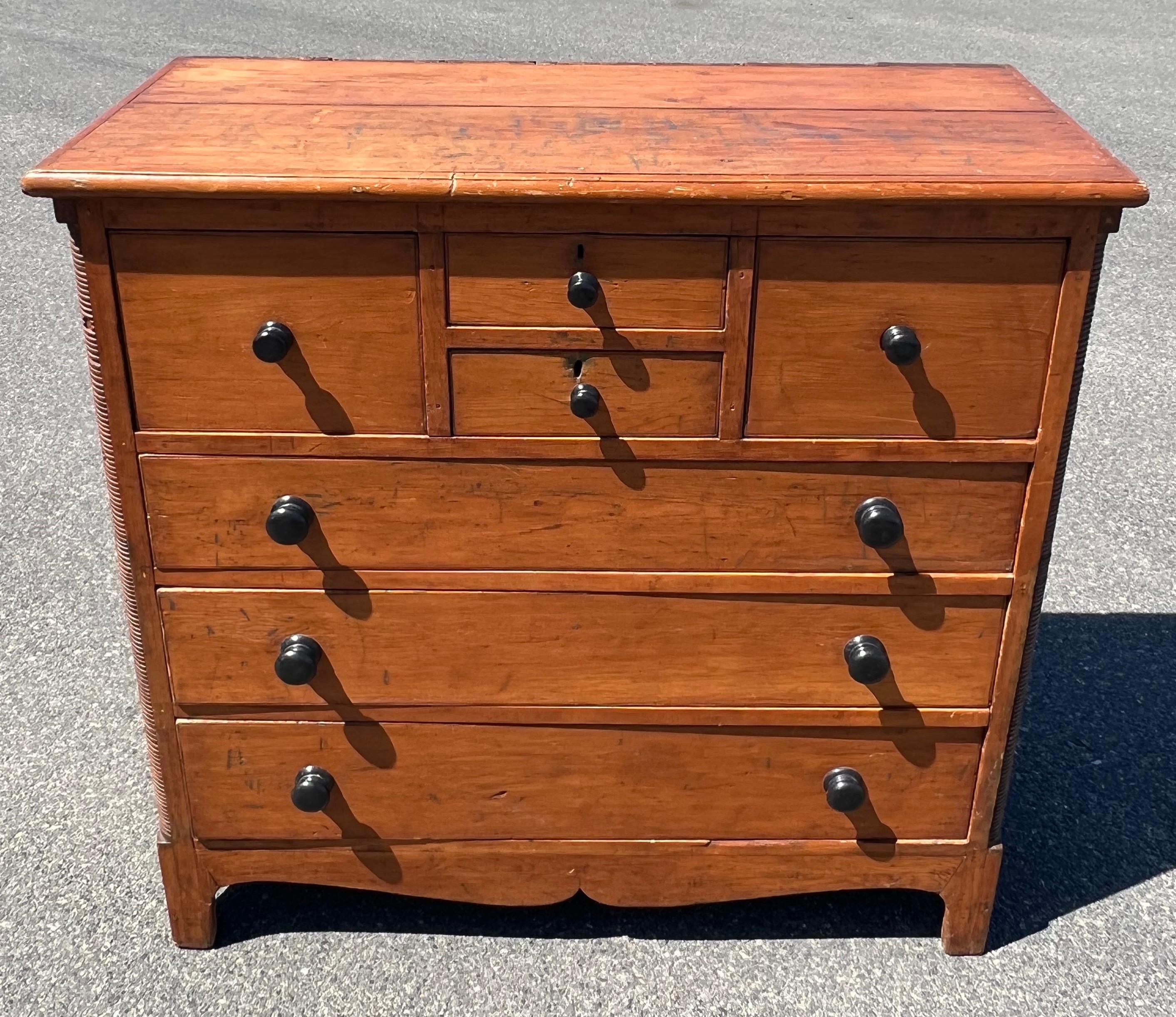 19th century large bonnet chest of drawers. Two small central drawers flanked by bonnet drawer on either side, over three full size drawers. With turned dark wood knobs, reeded corner quarter columns, and nicely shaped bracket base.