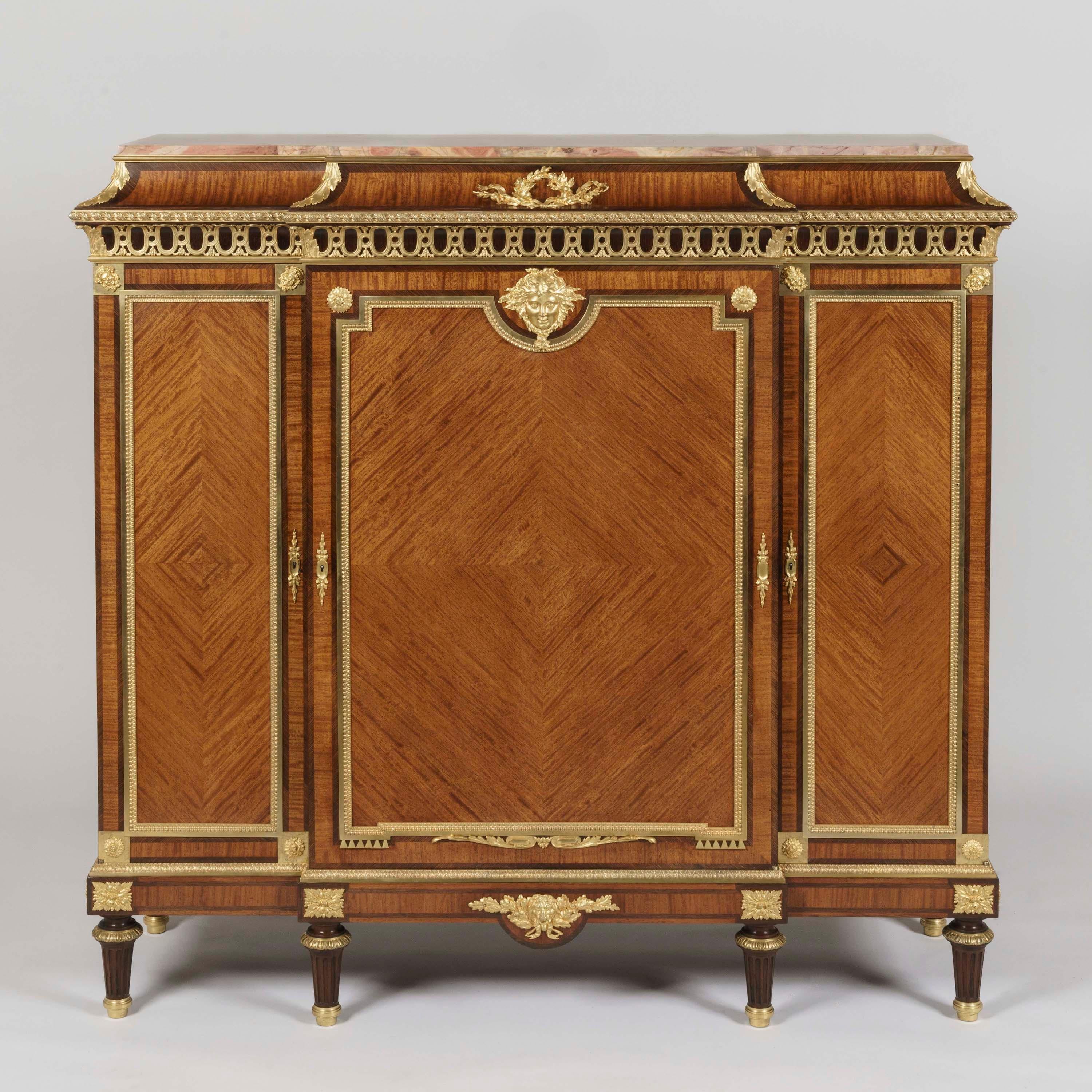 A Bois Citronnier Meuble d'Entre Deux
By François Linke

Constructed from satiné quarter-veneered bois citronnier, with rosewood crossbanding and ormolu mounts, the rectangular cabinet of slight breakfront proportions supported on tapering feet,