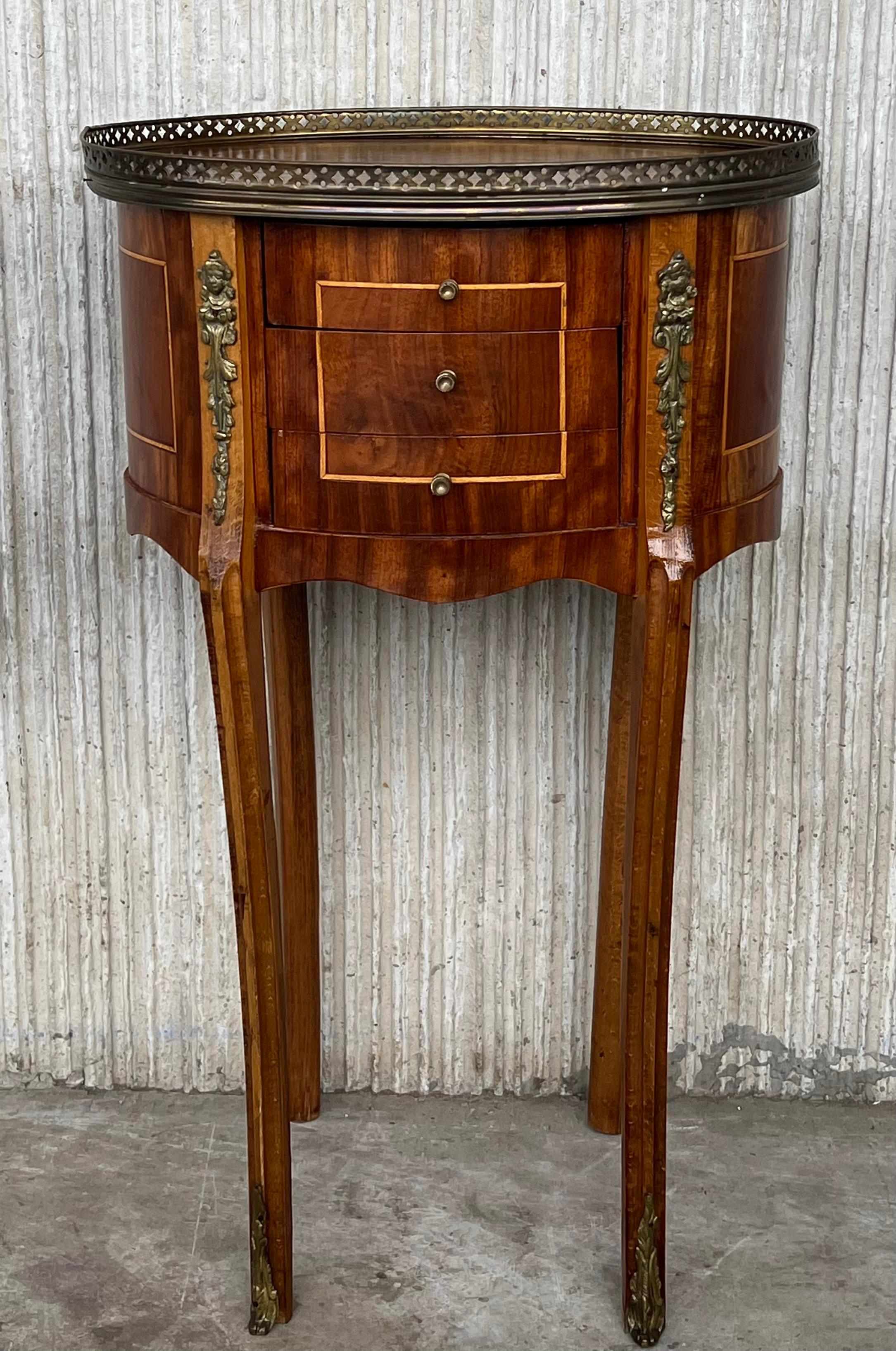 French Louis XVI style side table or nightstand topped with marquetry top, fluted legs finished with golden bronze clogs. Three dovetailed small drawers with brass details.