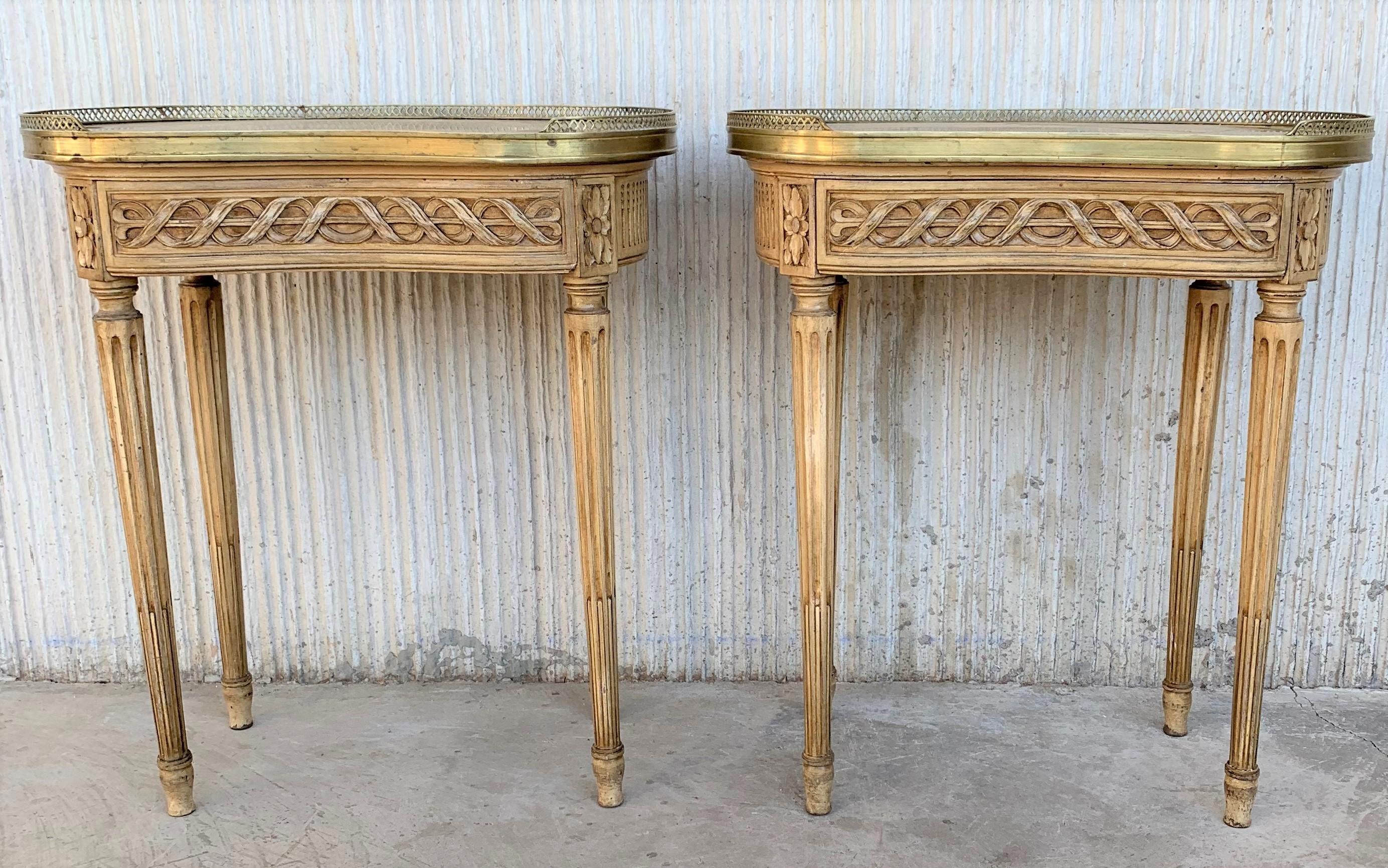 French Louis XVI style side table or nightstand topped with a white marble, fluted legs finished with golden bronze clogs. One dovetailed small drawer with brass details.

 