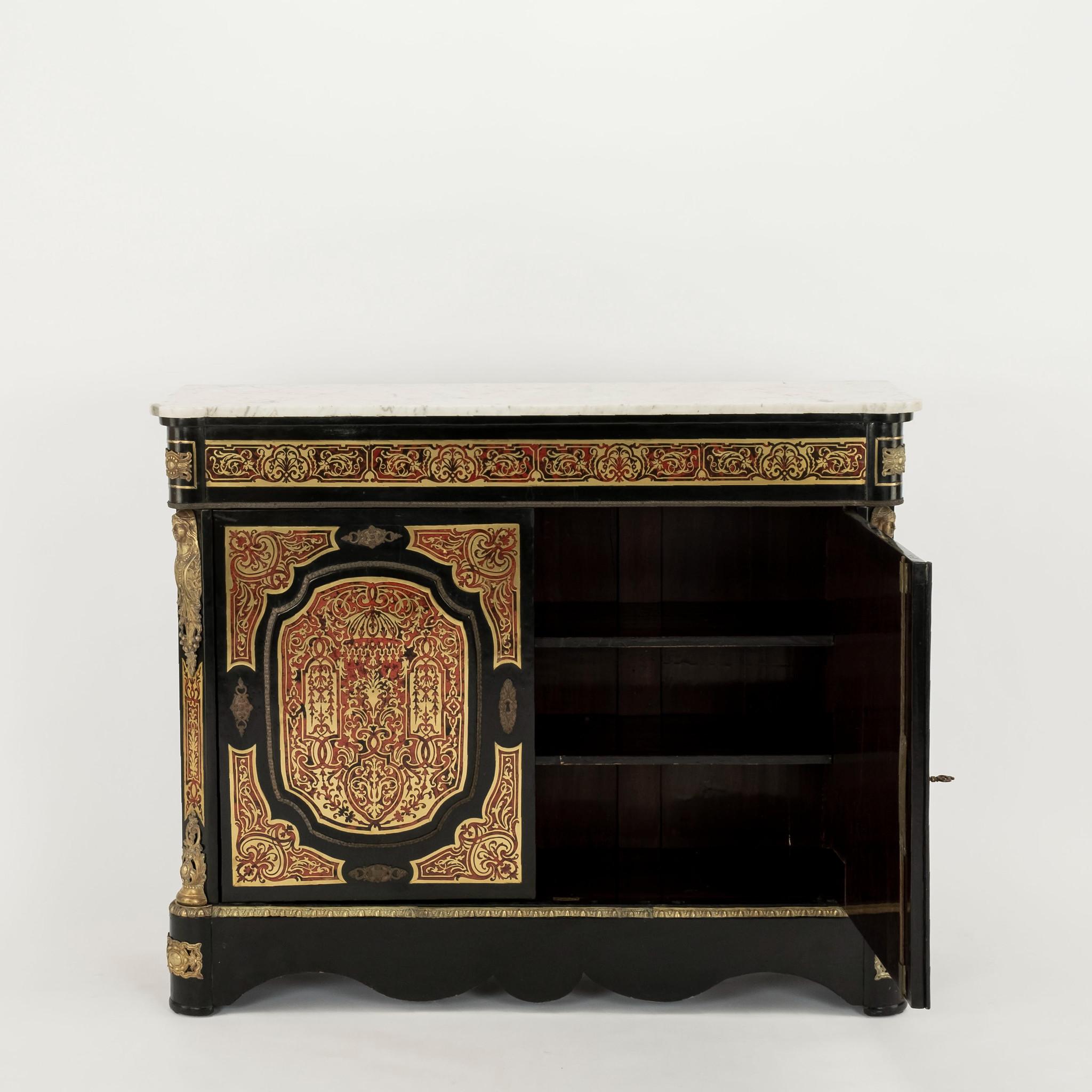 This French two door cabinet with marble top has an elaborate marquetry of tortoiseshell and brass. The decorations are complemented with brass moldings and appliqués.