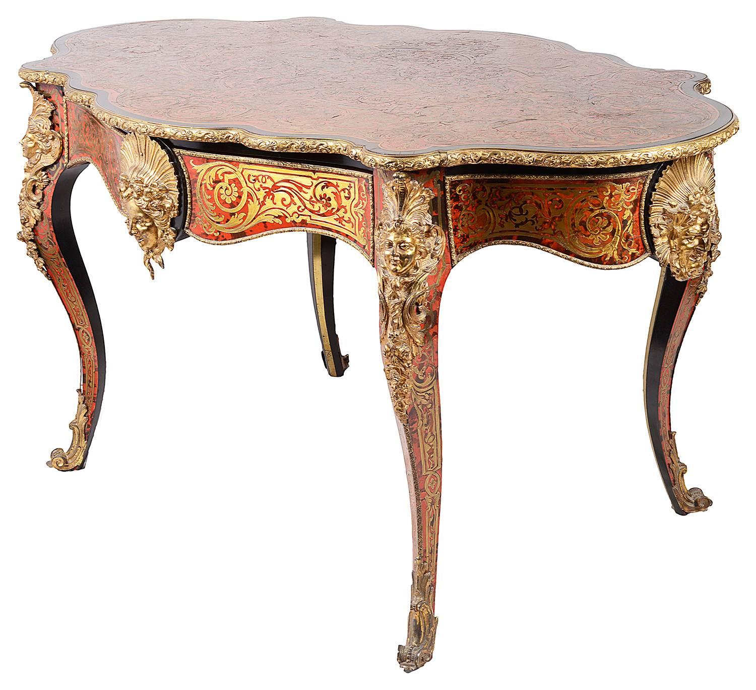 A good quality 19th century French Boulle inlaid serpentine shaped center table, having gilded ormolu mounts of sun bursts on four side, a mahogany lined frieze drawer and raised on elegant cabriole legs each with ormolu mounts, terminating in