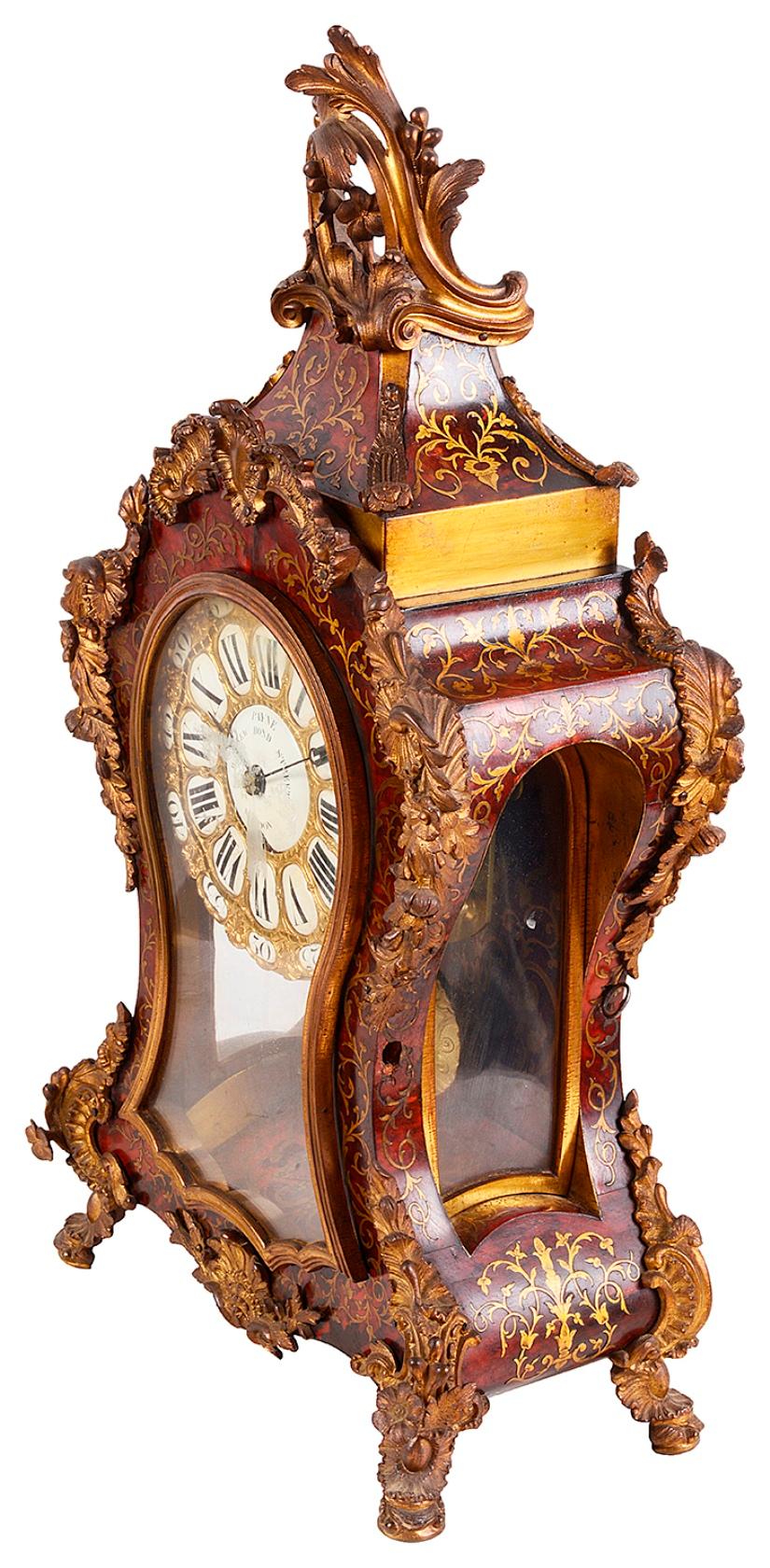 A very good quality 19th century French boulle mantel clock with wonderful scrolling foliate ormolu mounts to the surround, brass inlay to the red tortoiseshell. White enamel roman numerals to the eight day duration movement that chimes on the hour