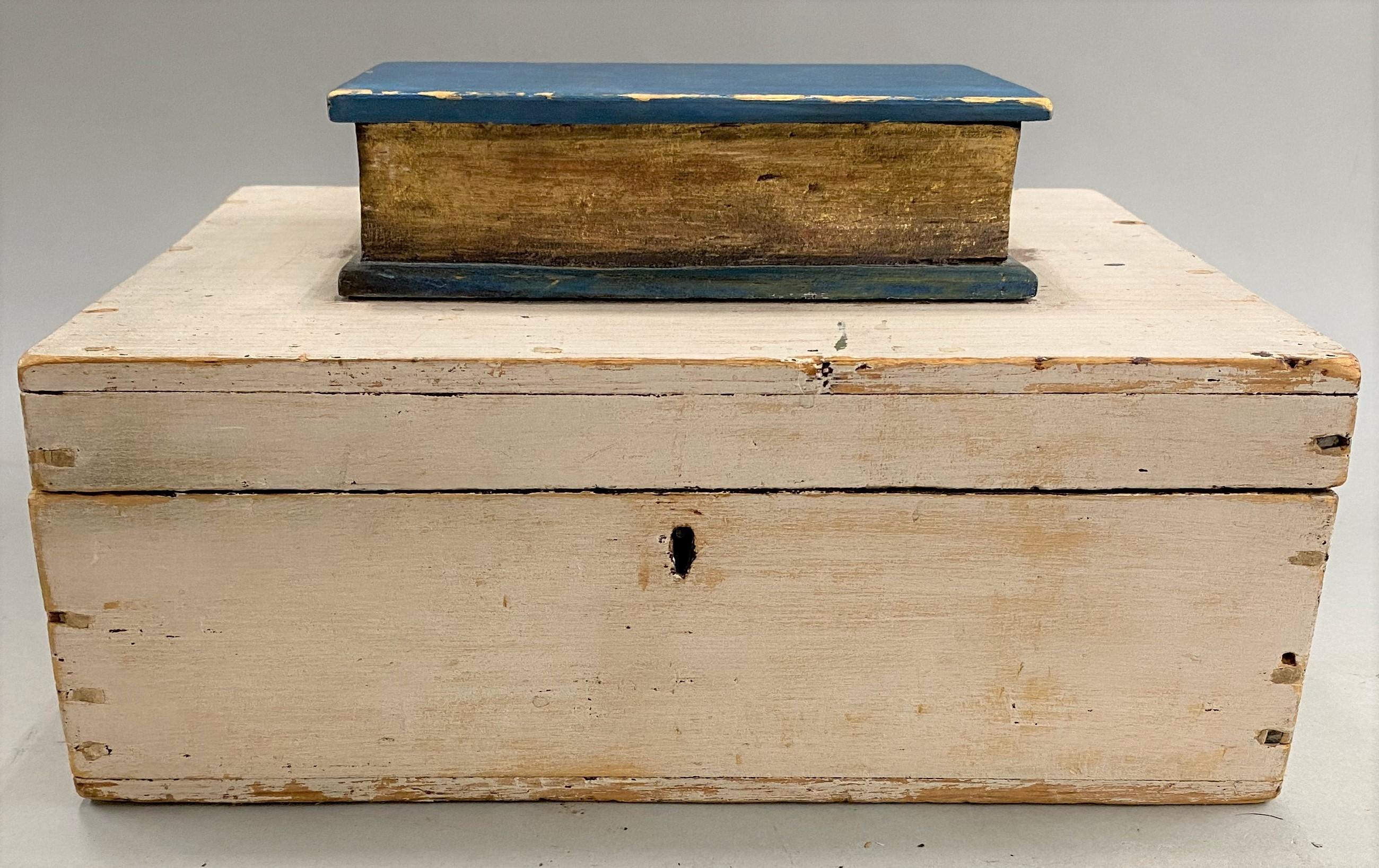 A fine wooden box with applied carved book on its top, all in original paint, with period wallpaper lining, American in origin, circa 1820. Possibly made as a wedding gift. The box has great overall patina and character, with minor rubs, losses, and