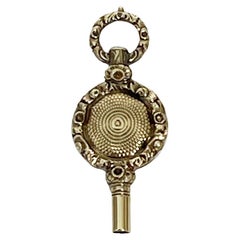 Chiave per orologio in ottone e oro del XIX secolo
