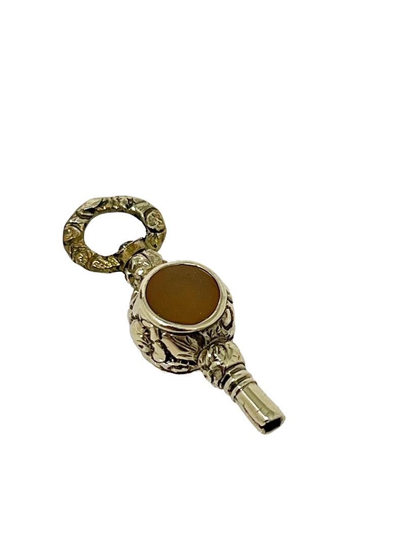 19th Century Brass and Gold Watch-Key with 2 different color Agate Stones

19th century brass and gold Watch-Key with each side a different Agate stone
A brass watch key , gold-plated with Agate stone in white and the other side an orange / yellow