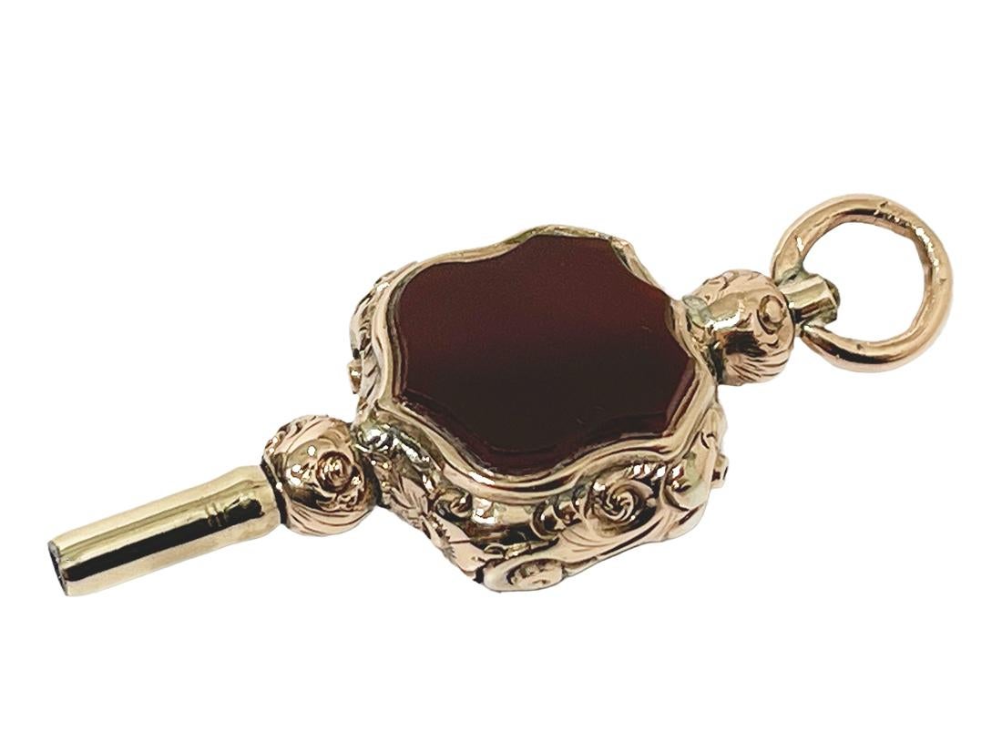 19th century brass and gold watch-key with each side a different stone in the shape of a shield.

Carnelian and Heliotrope brass gold-plated Watch-key in the shape of a shield.
Heliotrope is a protective, grounding and purifying stone. Helps you