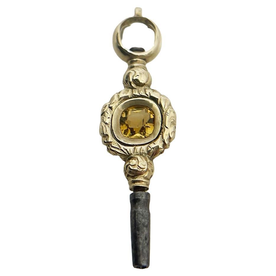 Uhrenschlüssel aus Messing und Gold des 19. Jahrhunderts mit Citrinstein