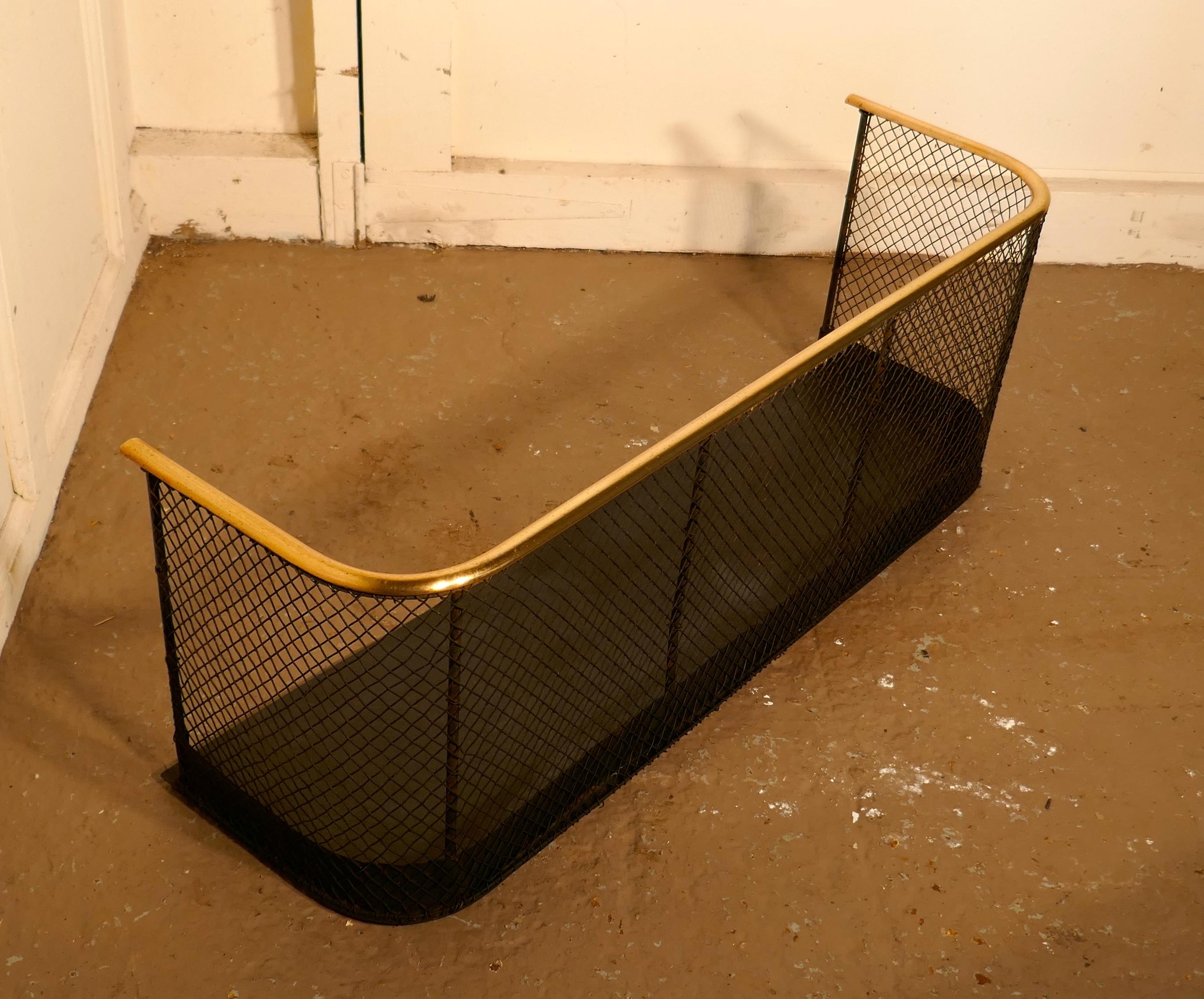 19th century brass and iron club fender.

A 19th century antique fire guard often known as a club fender, the iron guard has a mesh guard with a brass rail at the top
The fender is in good all round condition, and has good patination
Measures: