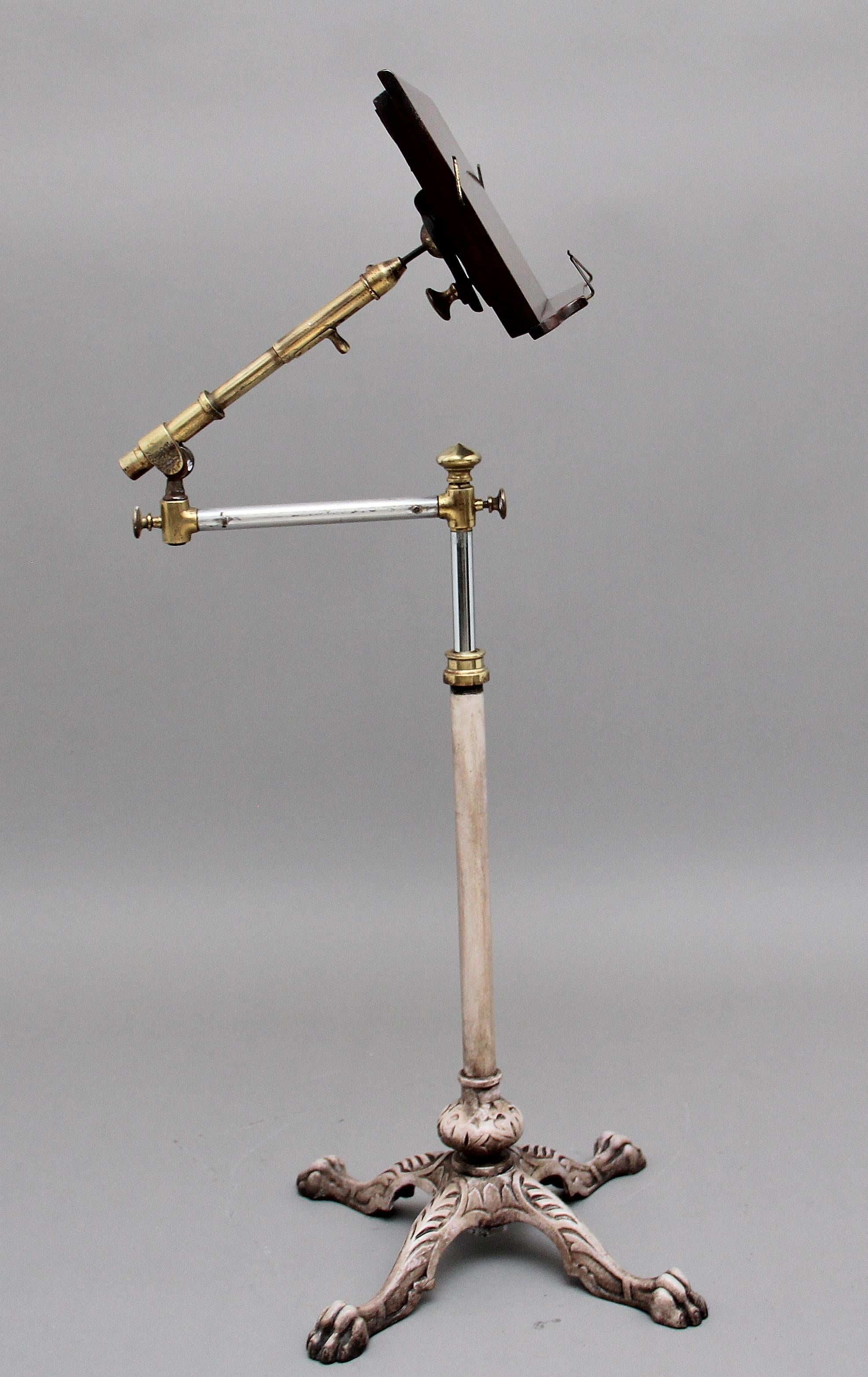 19th century metamorphic brass and mahogany reading /music stand, each section is fully adjustable and there is a tilt facility on the mahogany reading section, supported on a turned column with a very decorative engraved metal quad base with claw