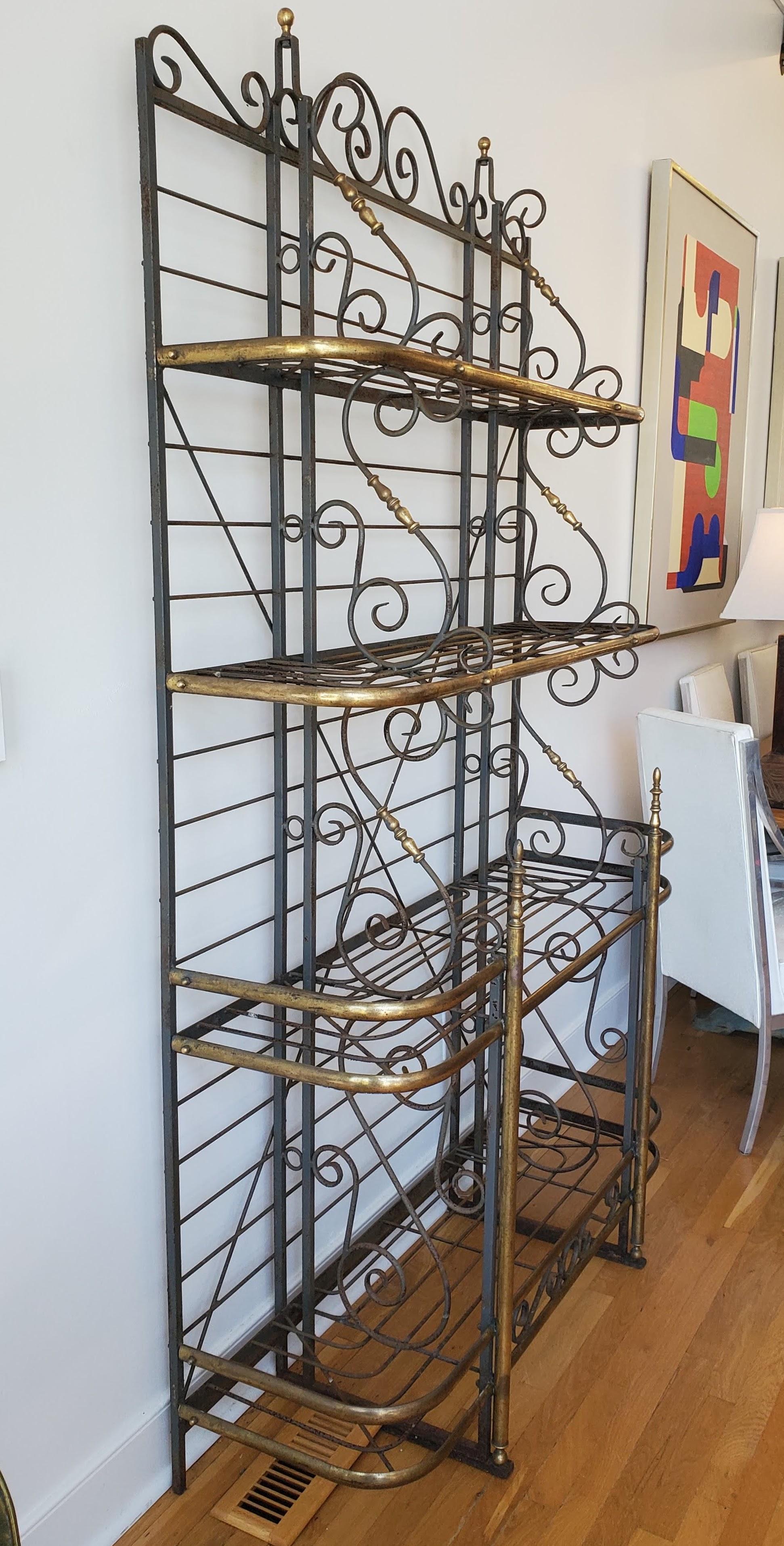 This large 19th century french provincial baker’s rack will make an excellent addition to the at home chef's kitchen. Plenty of space for all those knick-knacks and kitchen gadgets as this rack is 7 ft tall. Made of scrolled steel with decorative