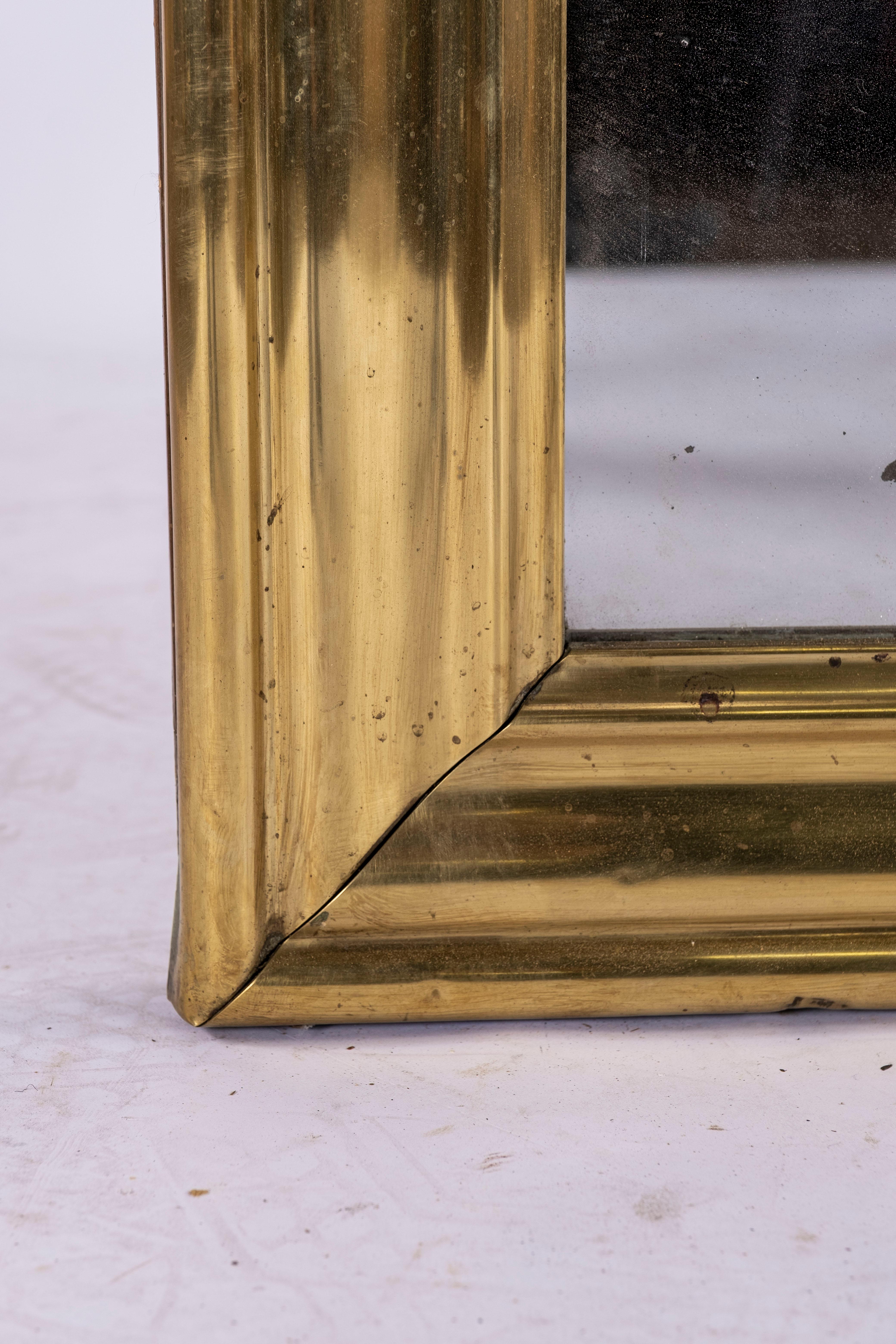 19th century brass bistro mirror from France. Original glass.