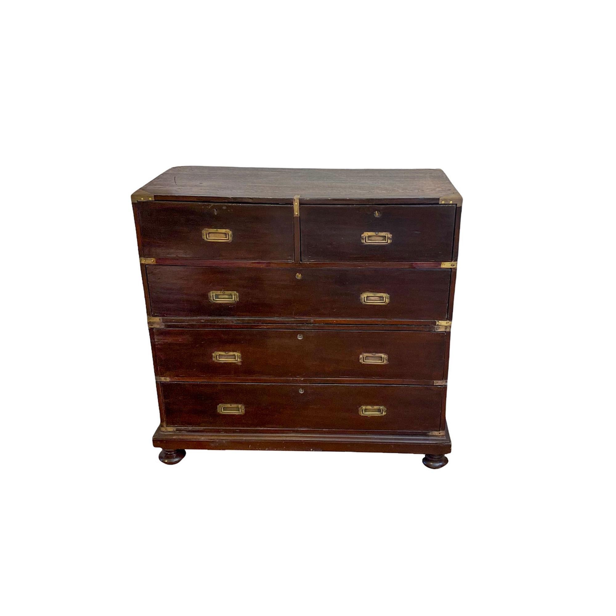 Mid 19th century two part campaign chest of drawers with recessed brass drawer pulls, lift handles and reinforcing hardware. The case in 2 parts with exposed dovetails to the top and with 2 short drawers above 3 long drawers with the lower half on a