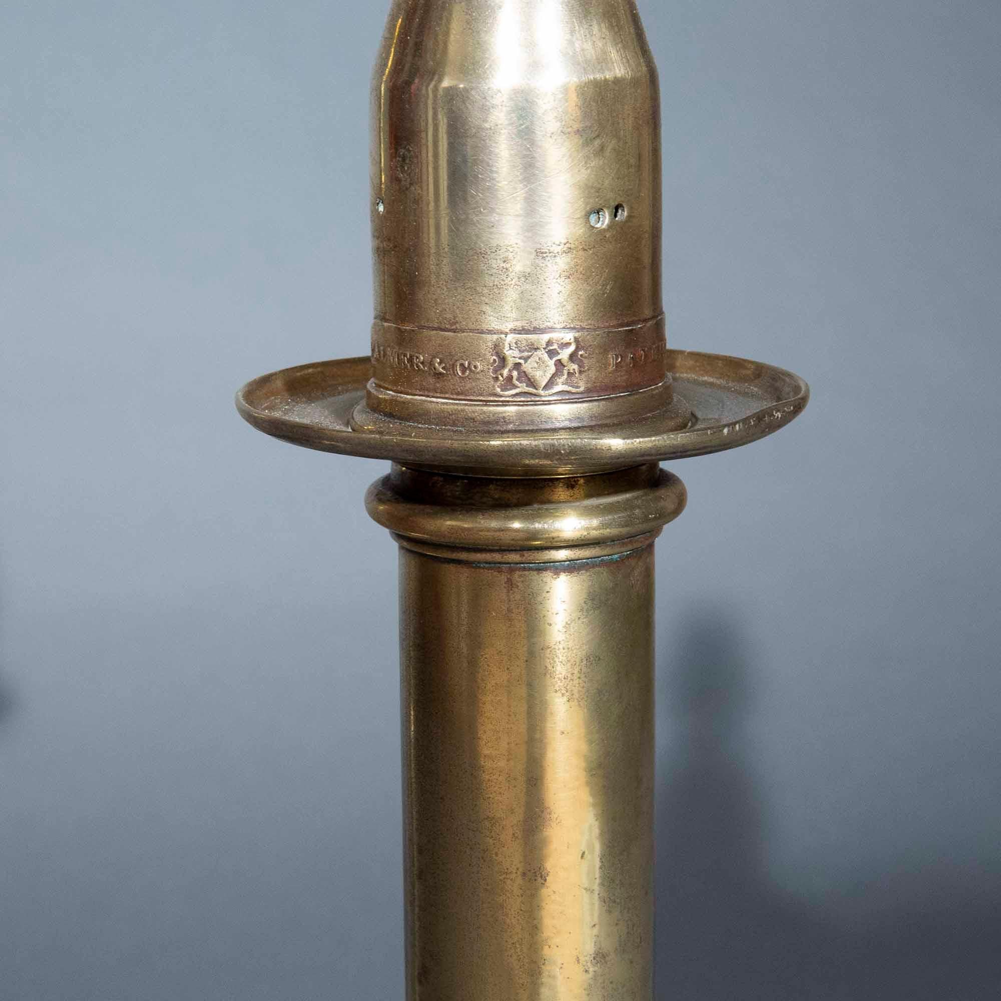 A pair of tall 19th century brass 'Palmer's Patent' candlestick lamps, 

English, circa 1845. 

Why we like them

This wonderfully chic pair of lamps is simple and sophisticated at the same time. Their sleek stems with a 'kink' in the middle evoke