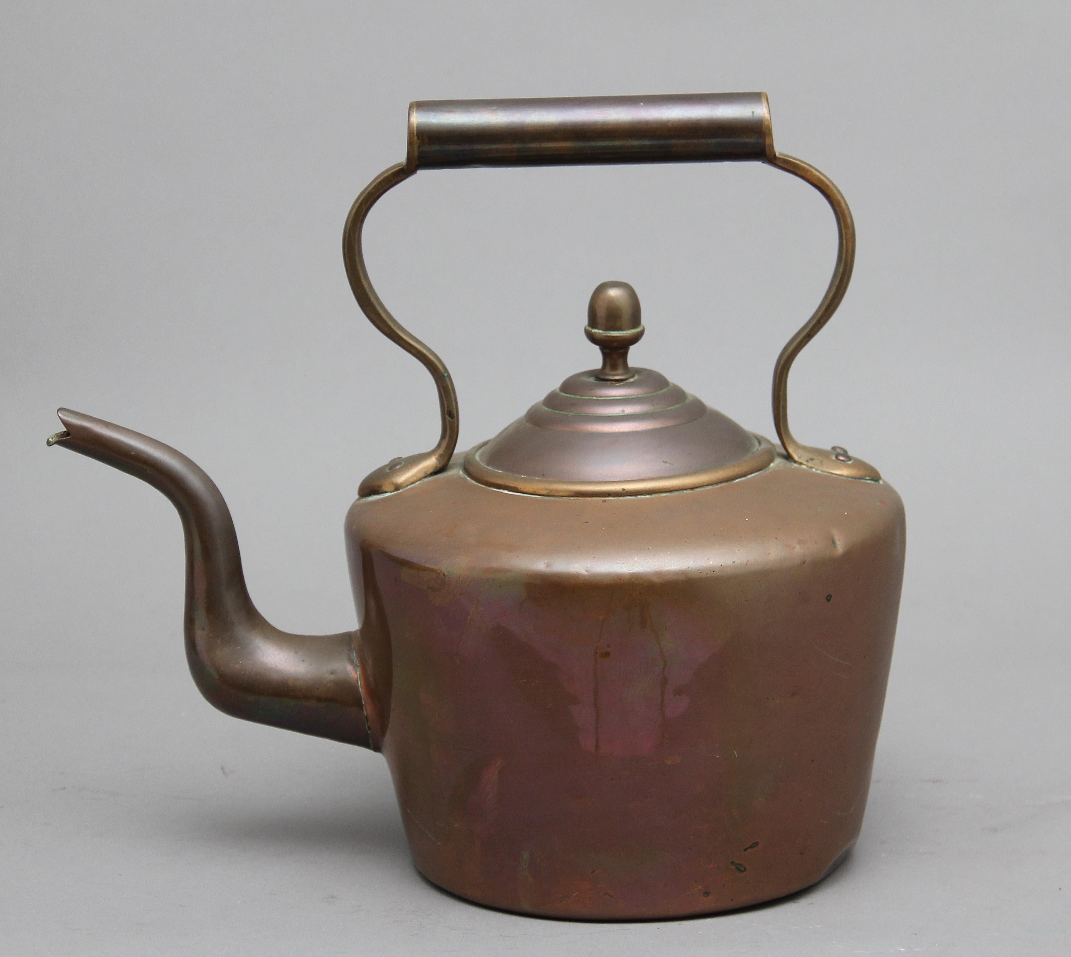 19th century brass copper kettle, having a shaped handle, acorn finial on the lid and a shaped spout, circa 1860.