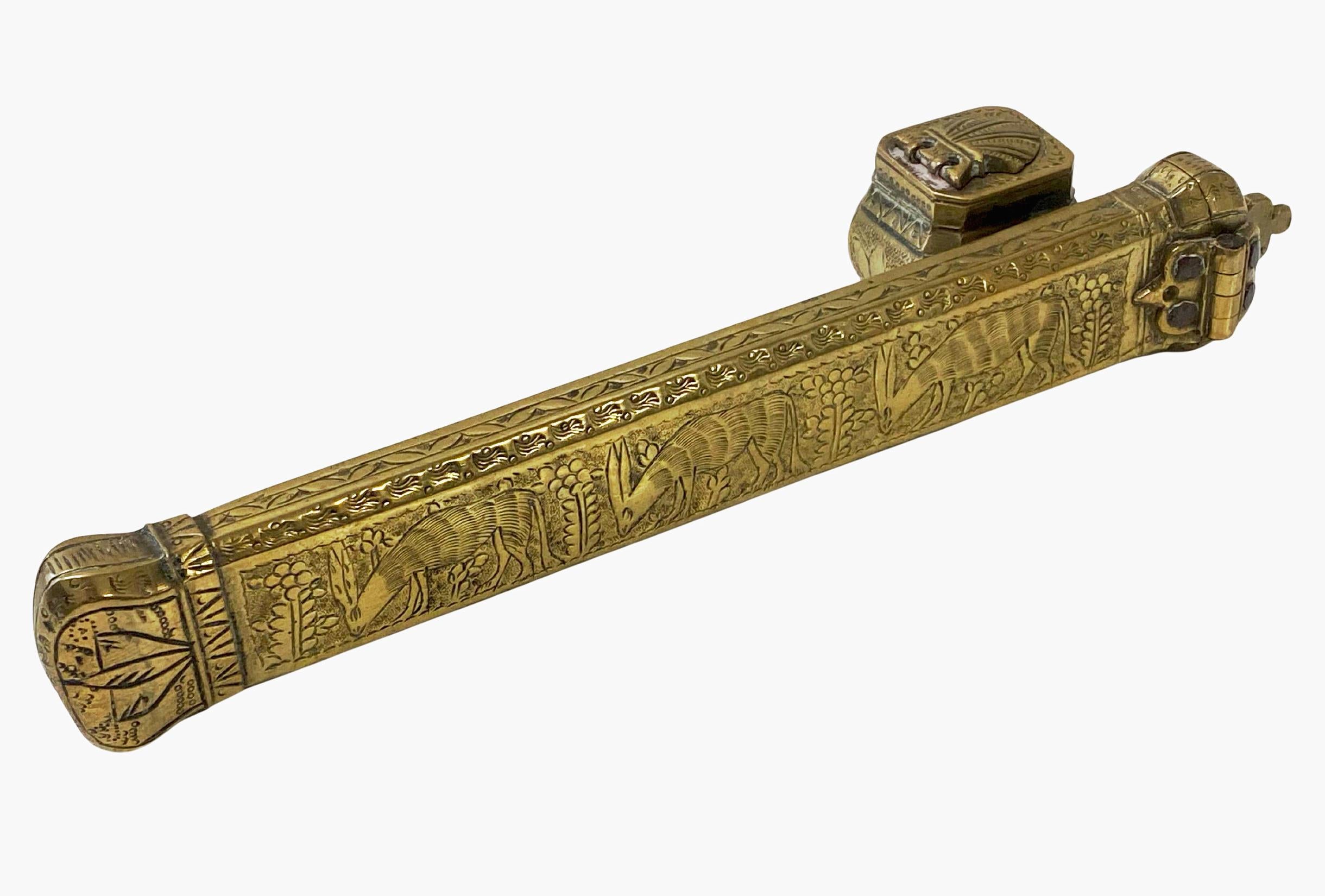 A 19th century brass decorated Middle Eastern Qalamdan. The Qalamdan is in solid brass, decorated on all sides with middle eastern calligraphy. Comprising an inkwell and a pen compartment of typical tubular form with an interior cavity to store a