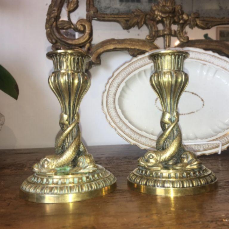 Pair of 19th century French bronze ormolu dolphin candlesticks. Measure: 6” height 4 1/8 diameter at base.