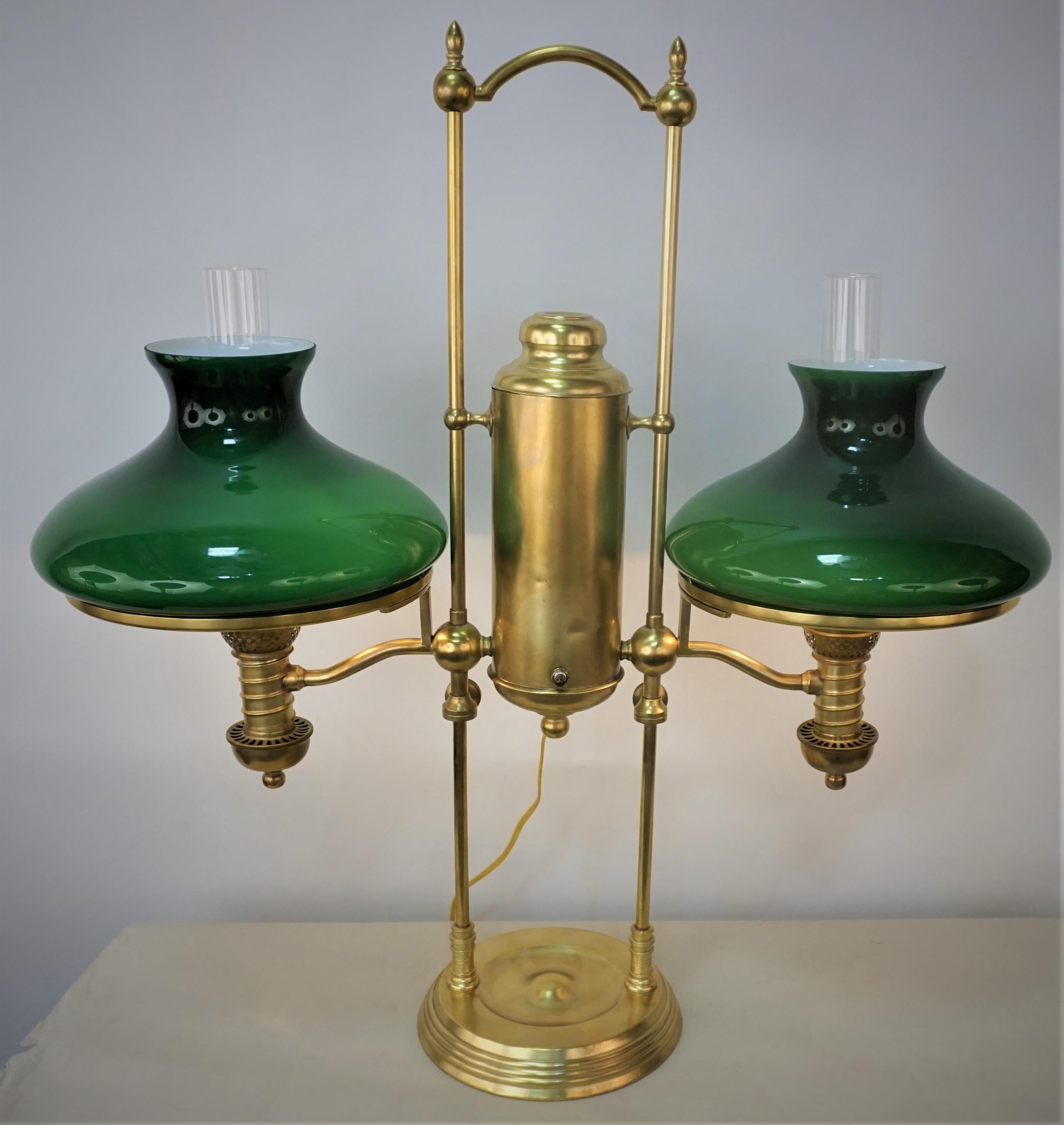 Electrified 19th American double light adjustable brass oil lamp with dark green case glass shades.