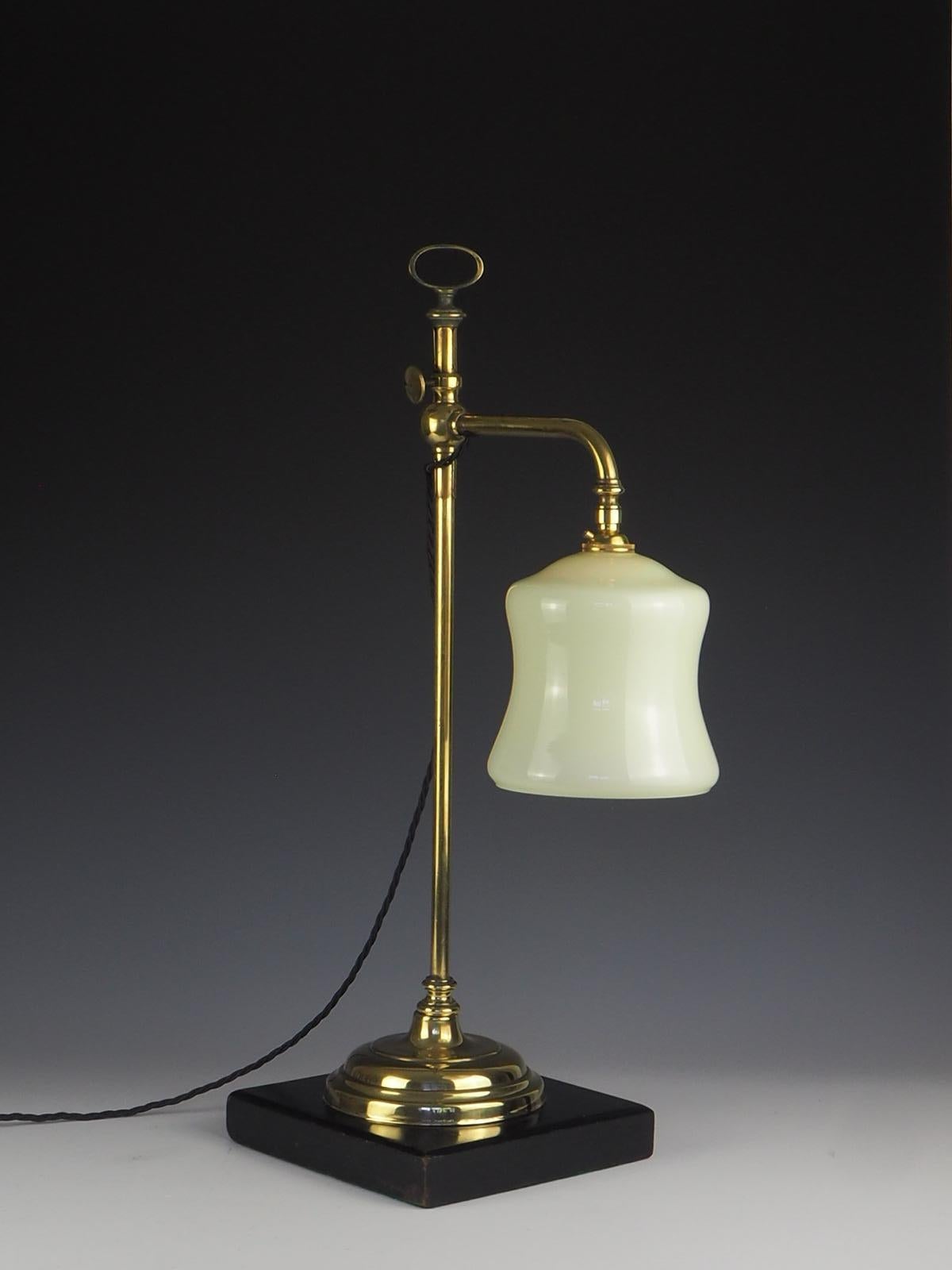 Antique 19th century rise and fall desk lamp.

Very heavy elegant desk lamp with solid ebonised wood base and brass rise and fall in working working order with beautiful opaline glass shade.

Original gas lamp now converted to electric.
