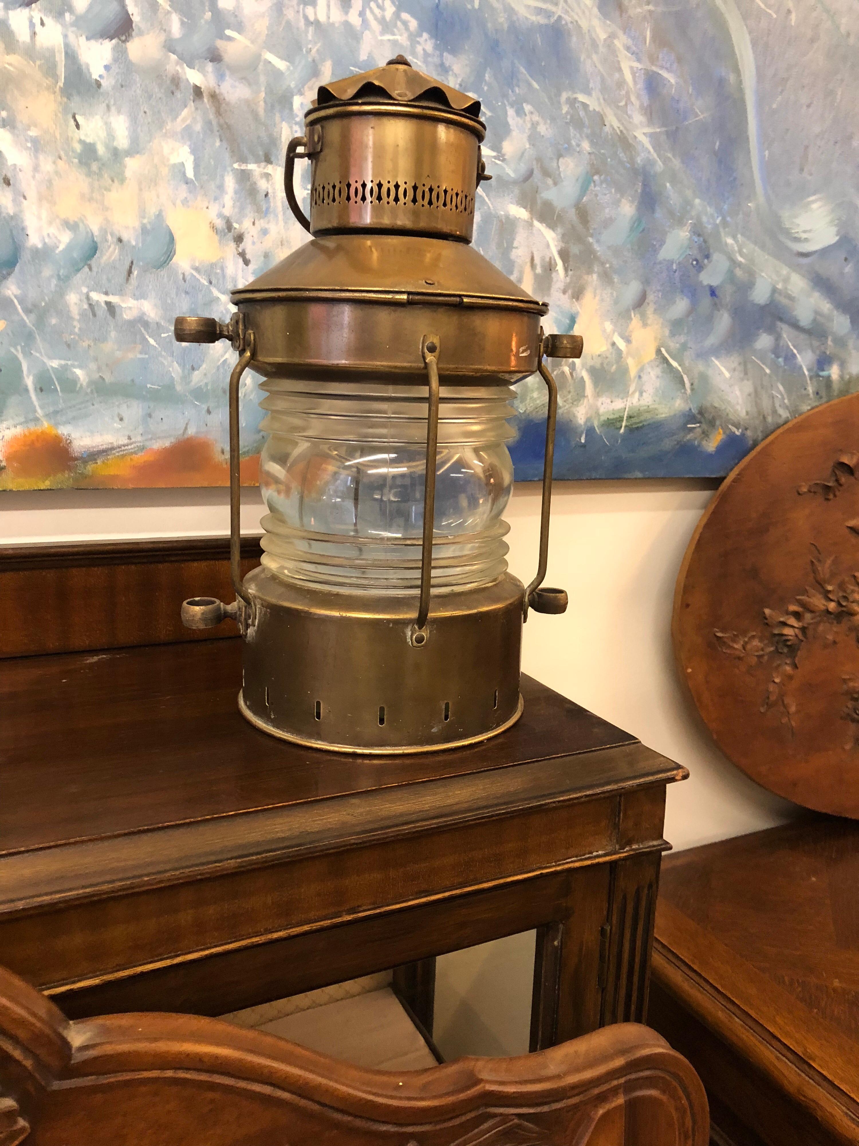 Beautiful Vintage Brass Lantern - ANKERLICHT.
Vintage Ankerlicht brass ships lantern from the Netherlands re-purposed into an electric lamp. Features a thick, clear glass 360 degree lens. Hinged top that opens to access the interior light. 
Very