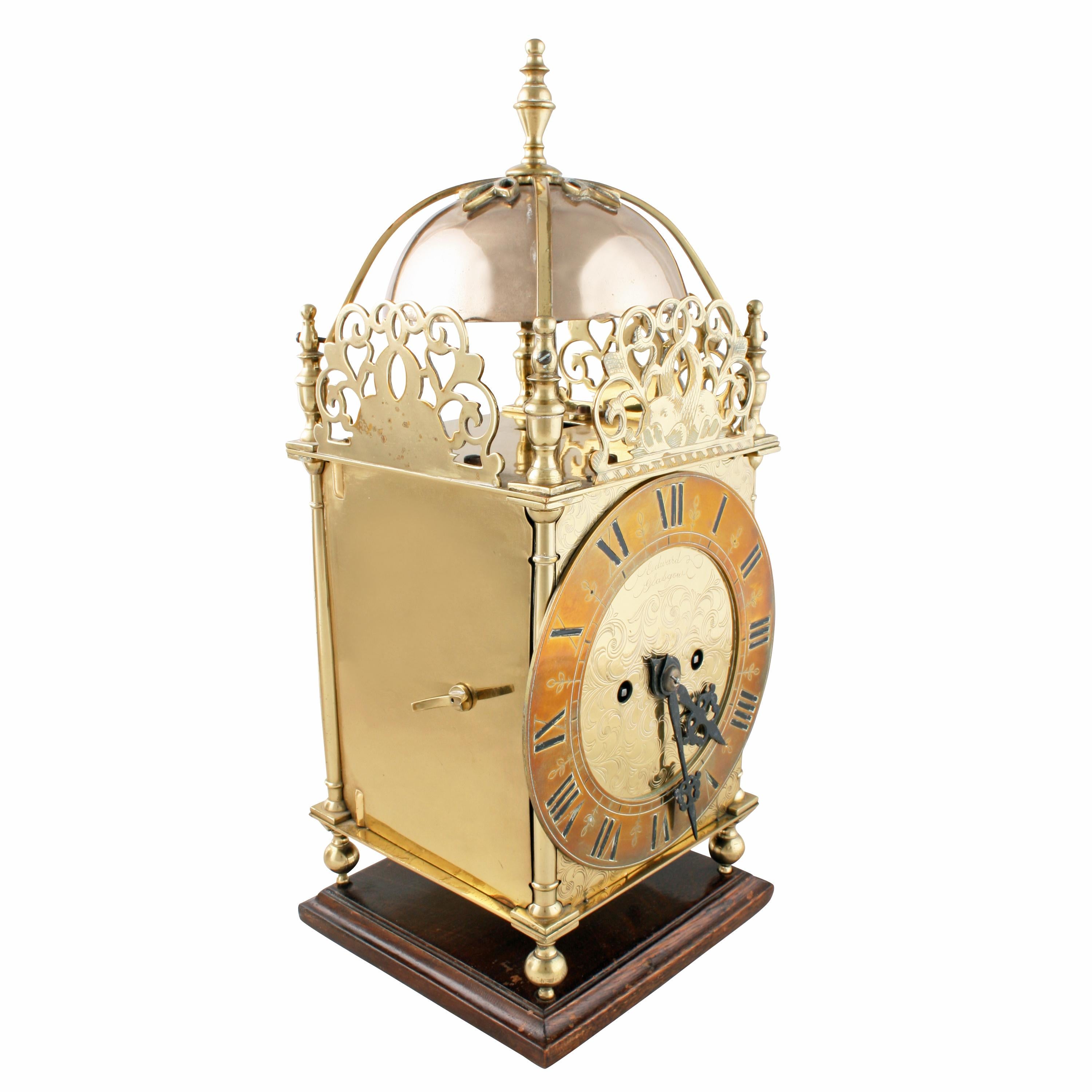 A late 19th century style brass lantern clock.

The clock has a double fusee movement that strikes the hour on a single bell and the quarters on two bells.

The clock has a domed top that consists of the two bells, one inside the other with two